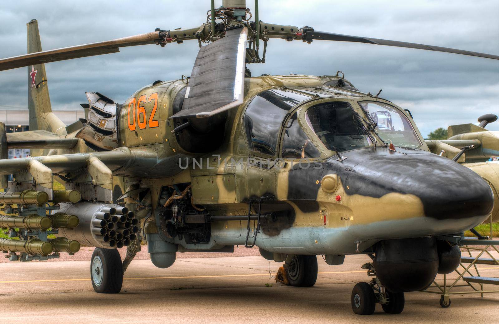 russian military helicopter on the ground with sky in background