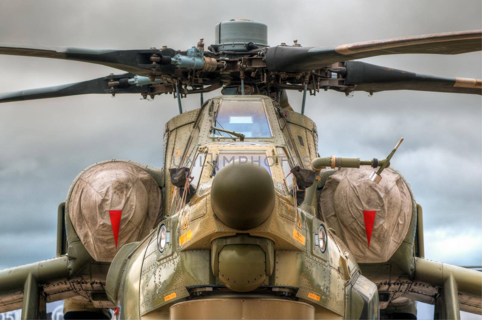 details of the russian military helicopter on the ground with sky in background