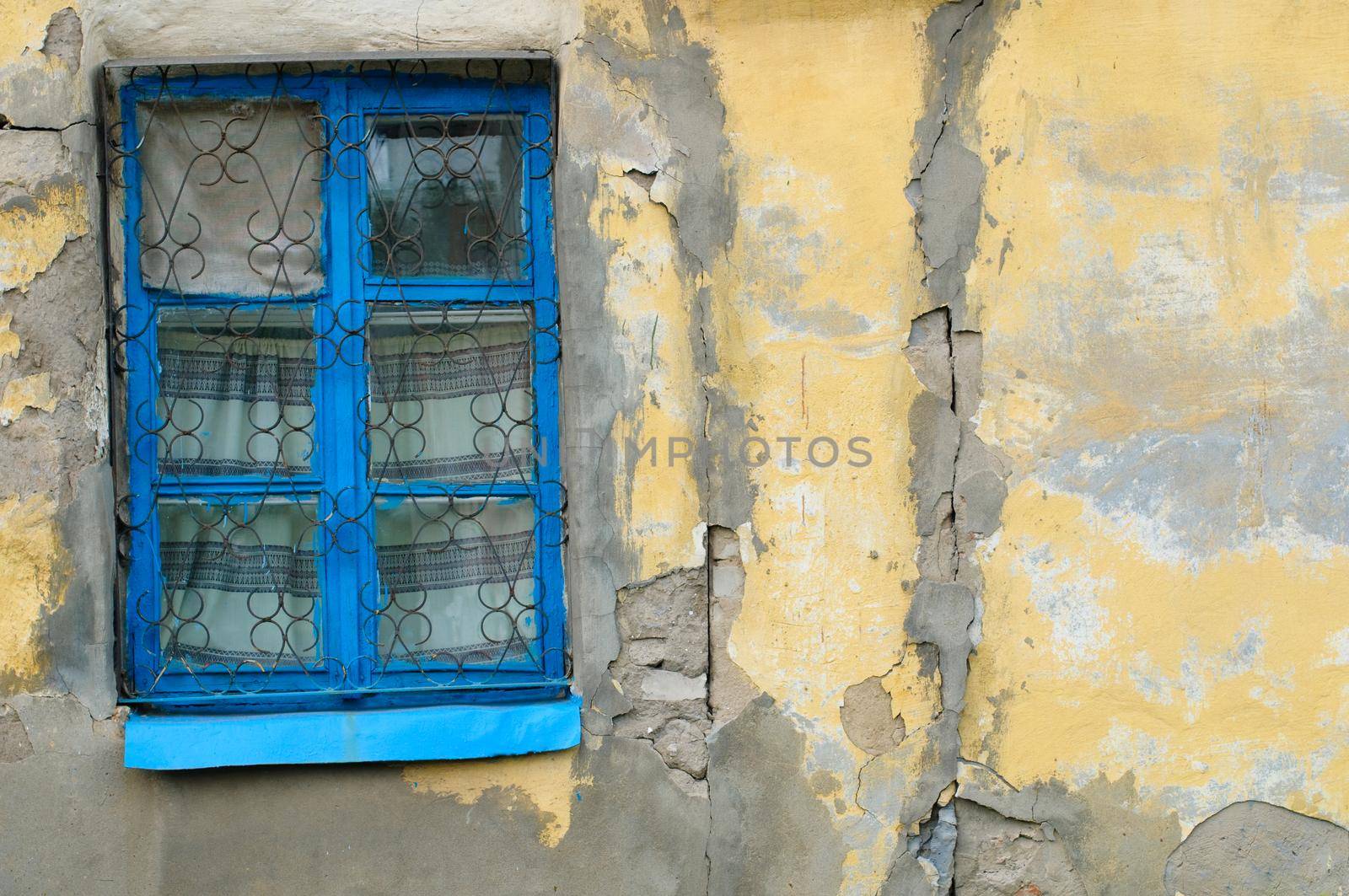 old window on facade of the old house