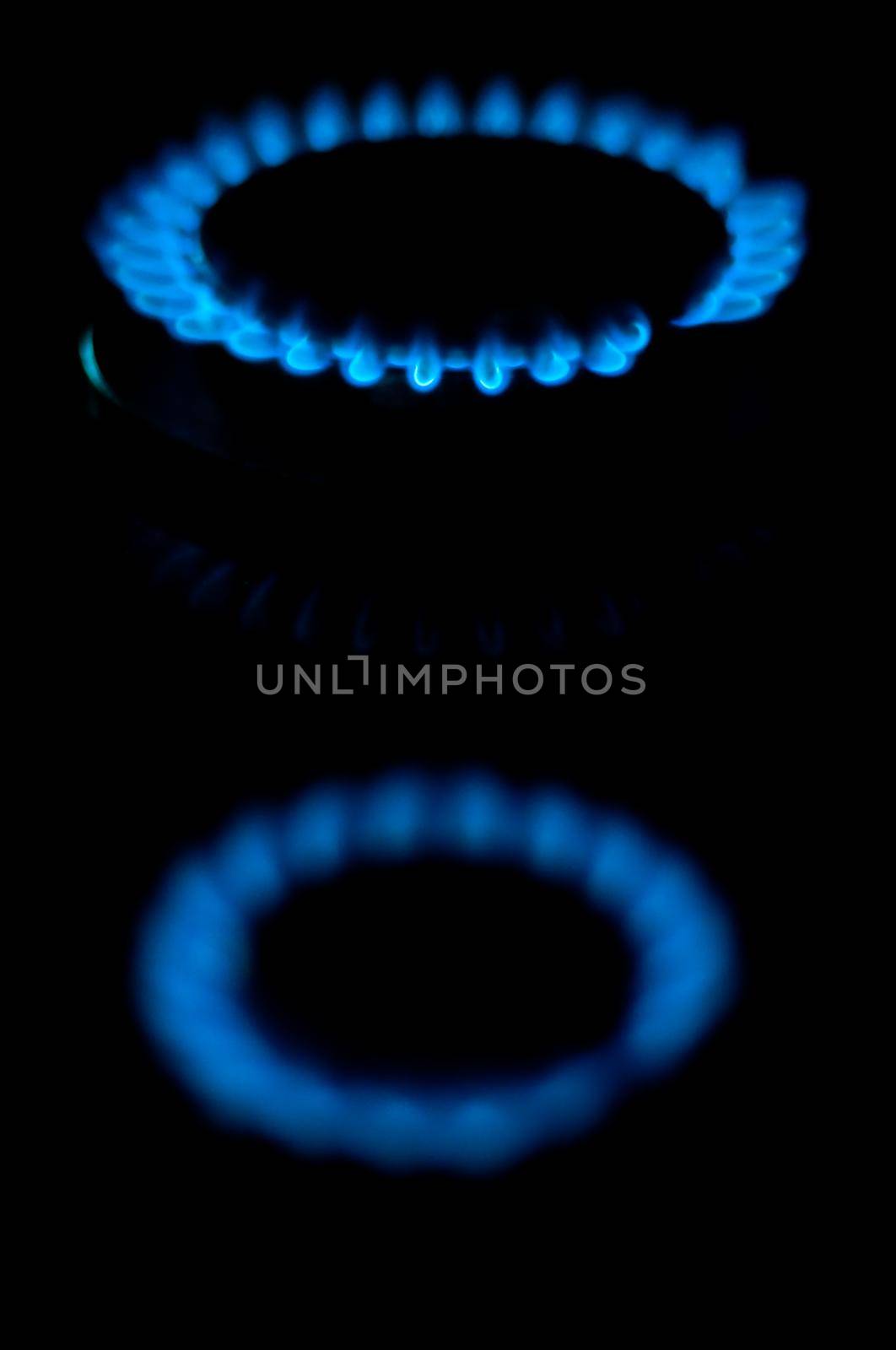 kitchen gas burning with blue flame isolated on black background