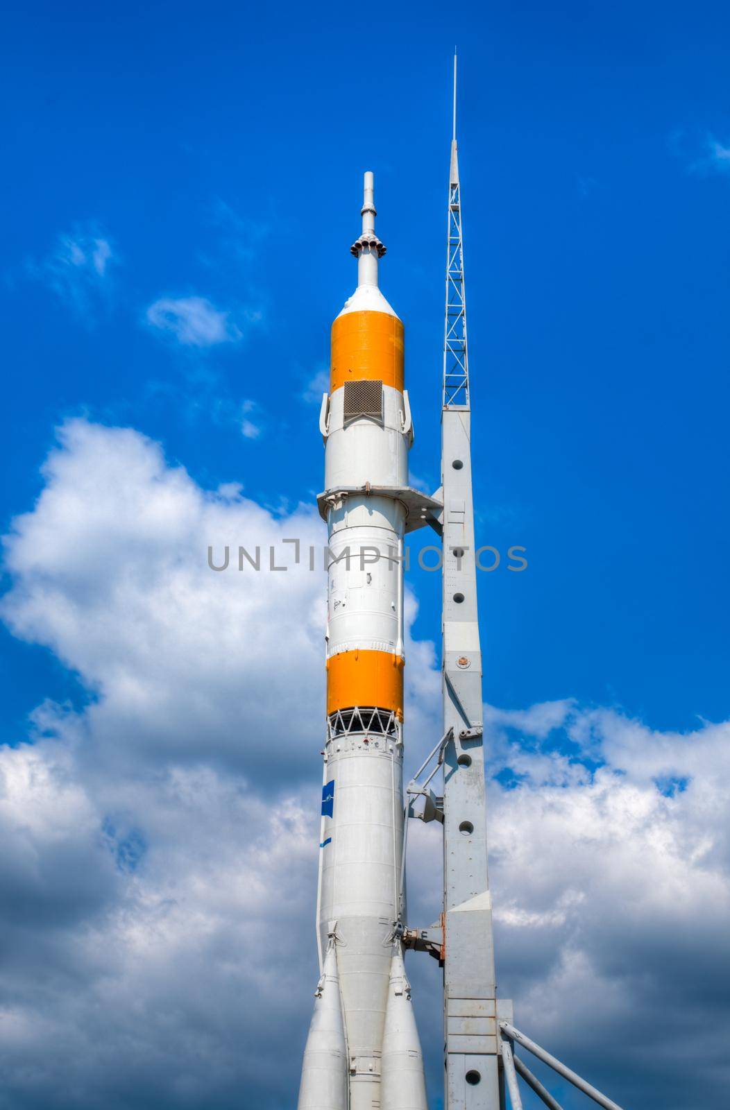 space rocket ready to go at the start bed with blue cloudy sky in background