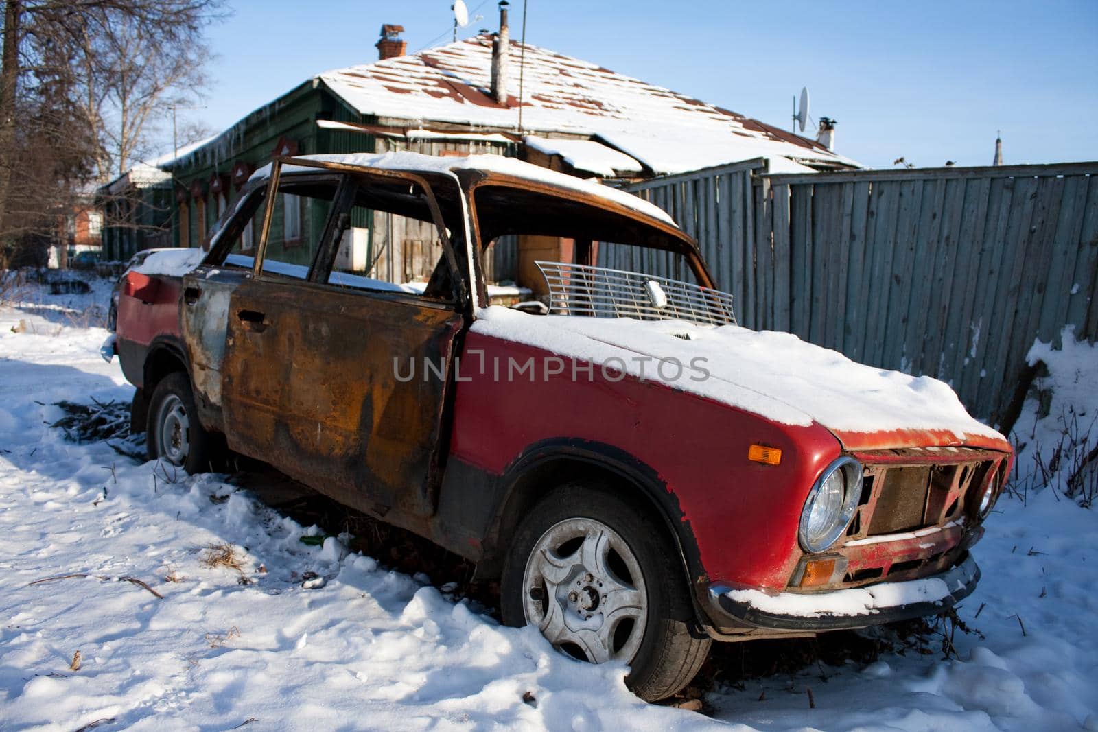 photo of old rusty car covered with snow