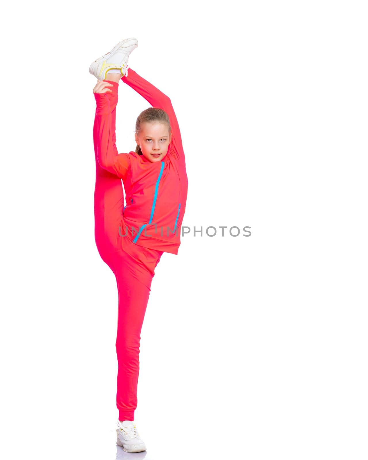 A girl gymnast balances on one leg.The concept of childhood, sport, a healthy lifestyle. Isolated on white background.