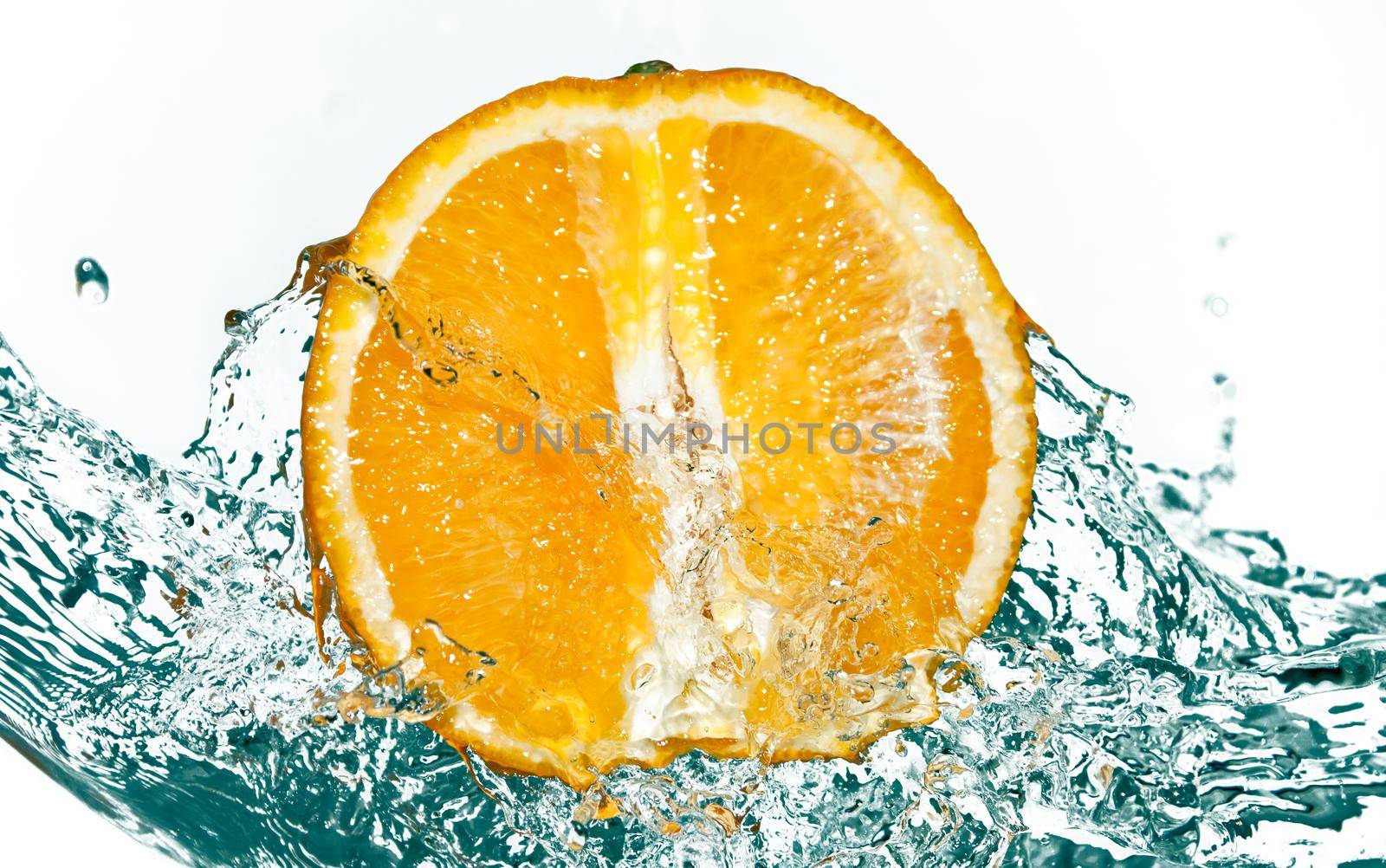 photo of water splash on half of orange