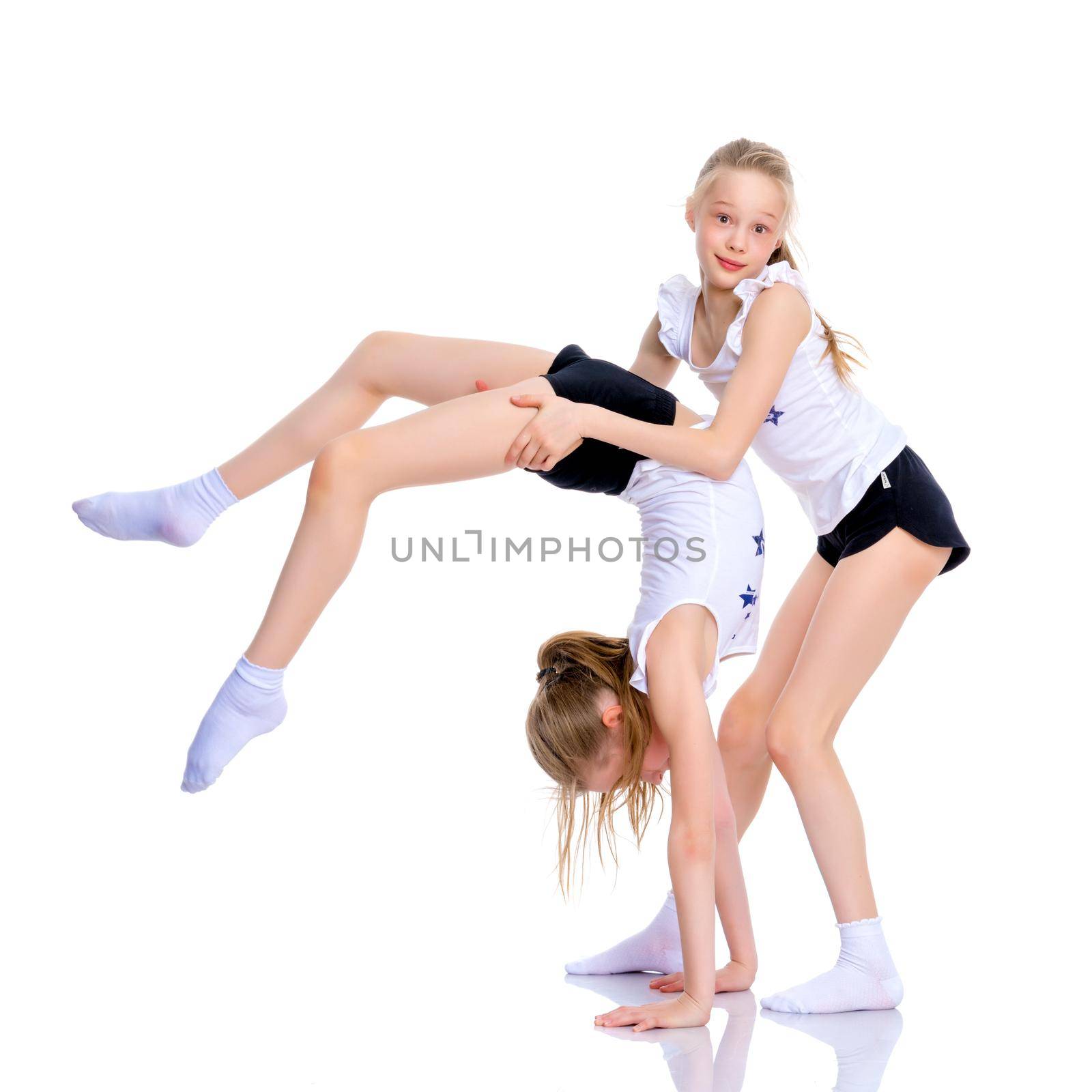 Girls gymnasts perform exercises. by kolesnikov_studio