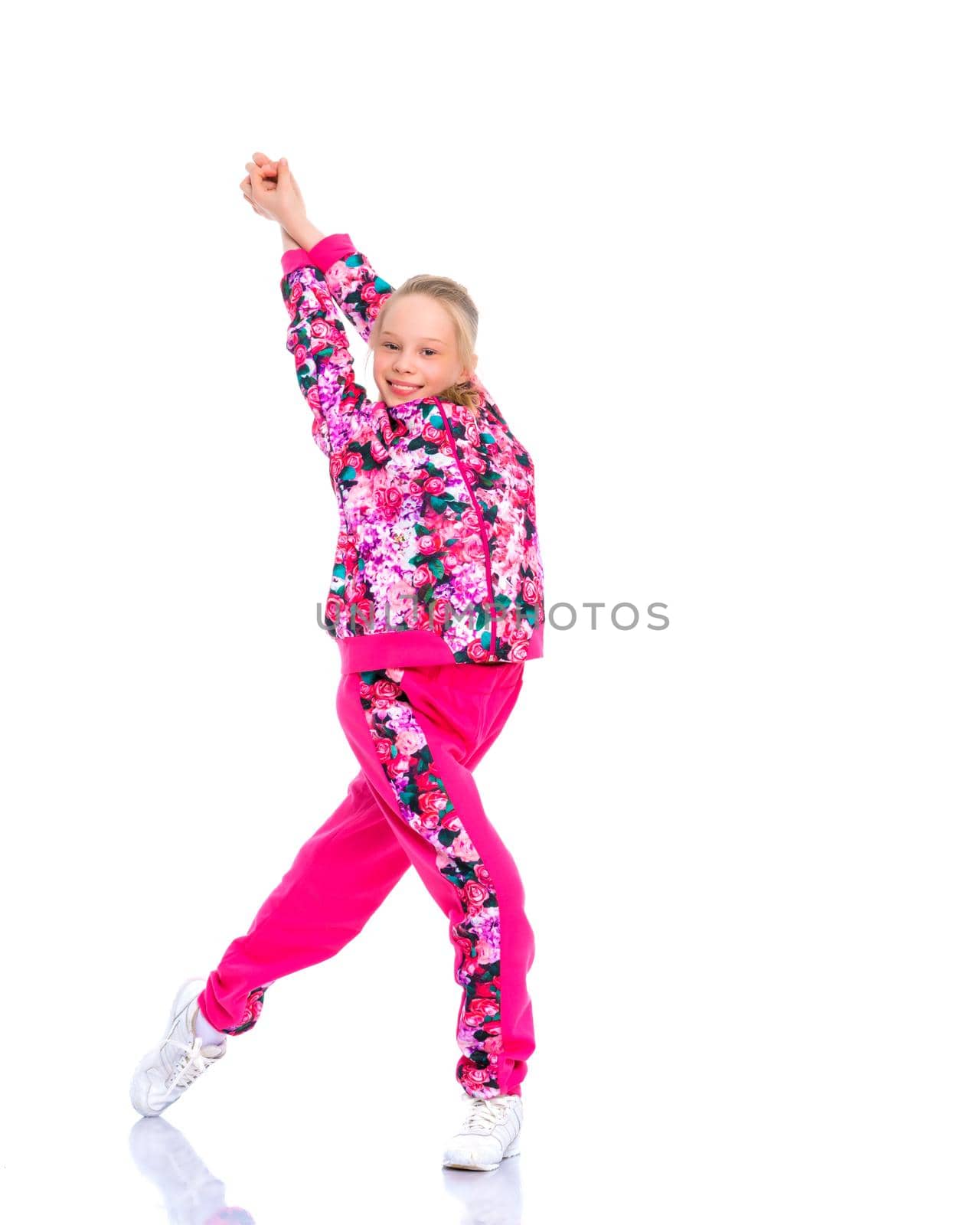 A girl gymnast performs an acrobatic element. The concept of childhood, sport, healthy lifestyle. Isolated on white background.