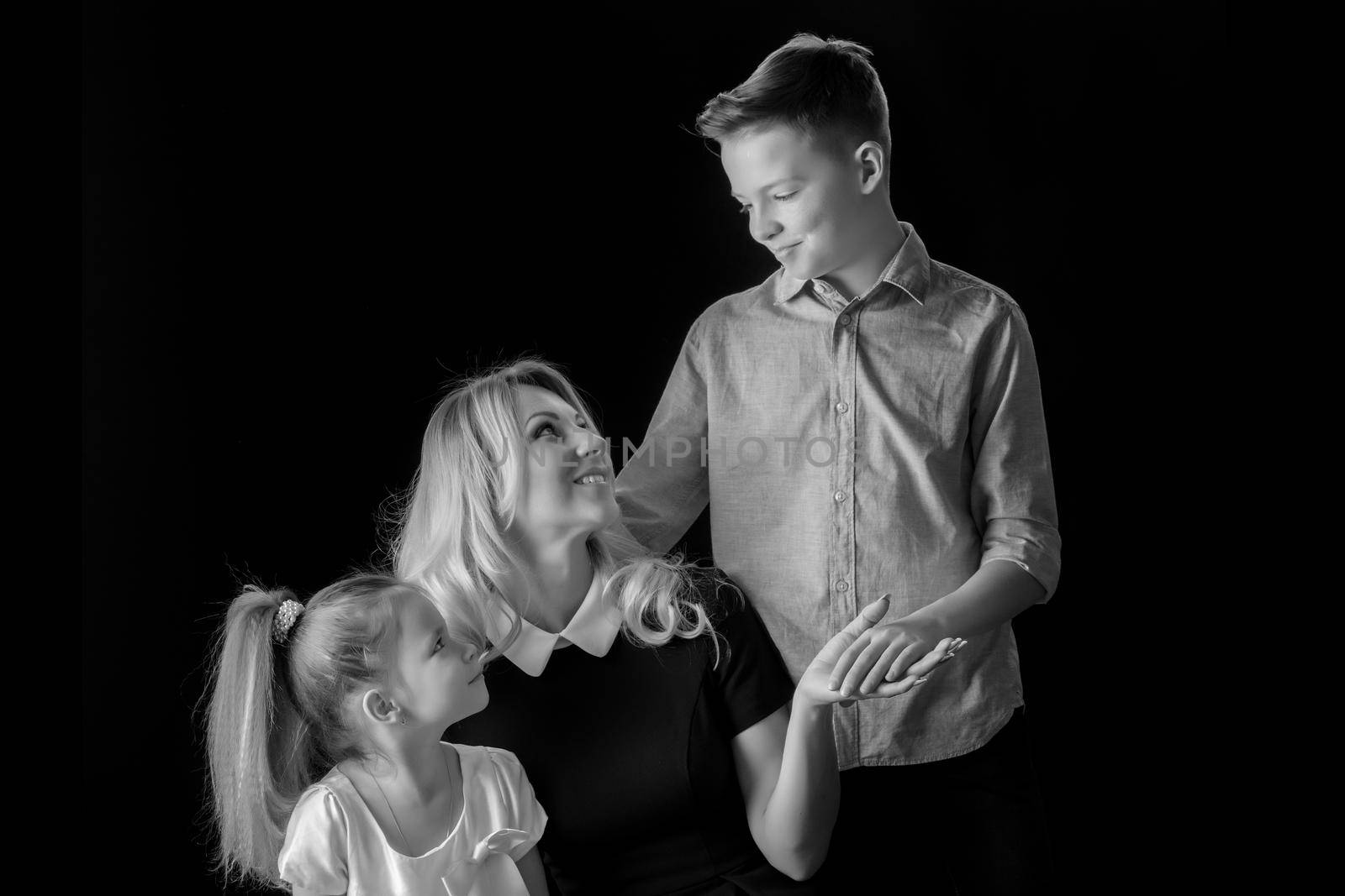 Young mother with her son and daughter studio black-and-white ph by kolesnikov_studio