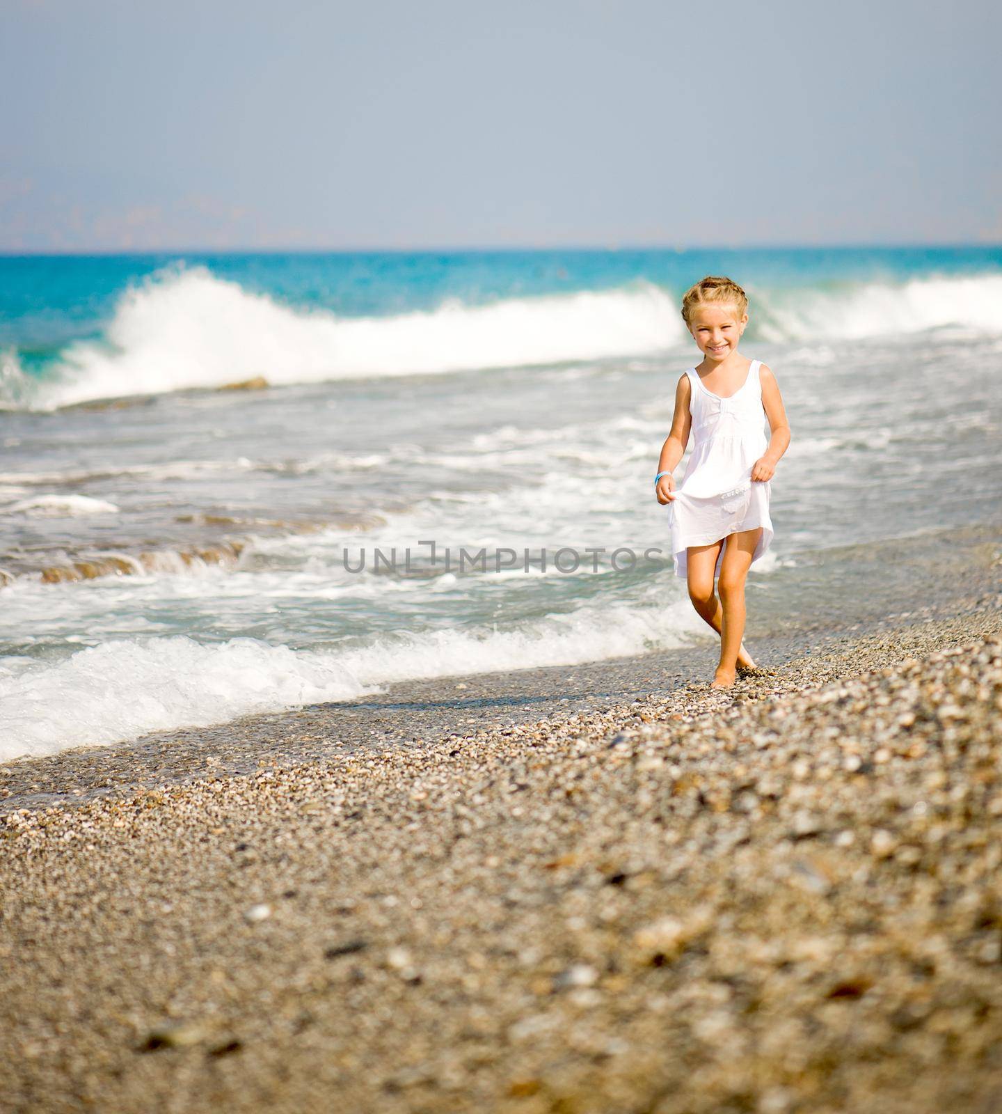 pretty little girl on tropical beach vacation