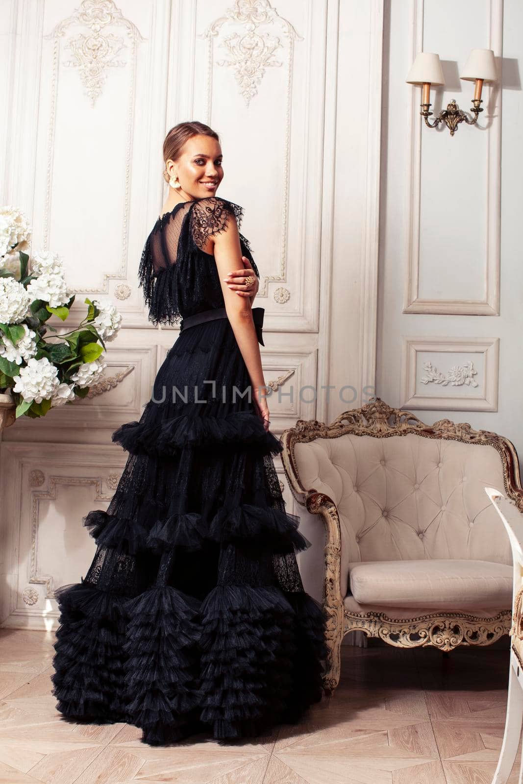 young pretty lady in black lace fashion style dress posing in rich interior of royal hotel room, luxury lifestyle people concept close up
