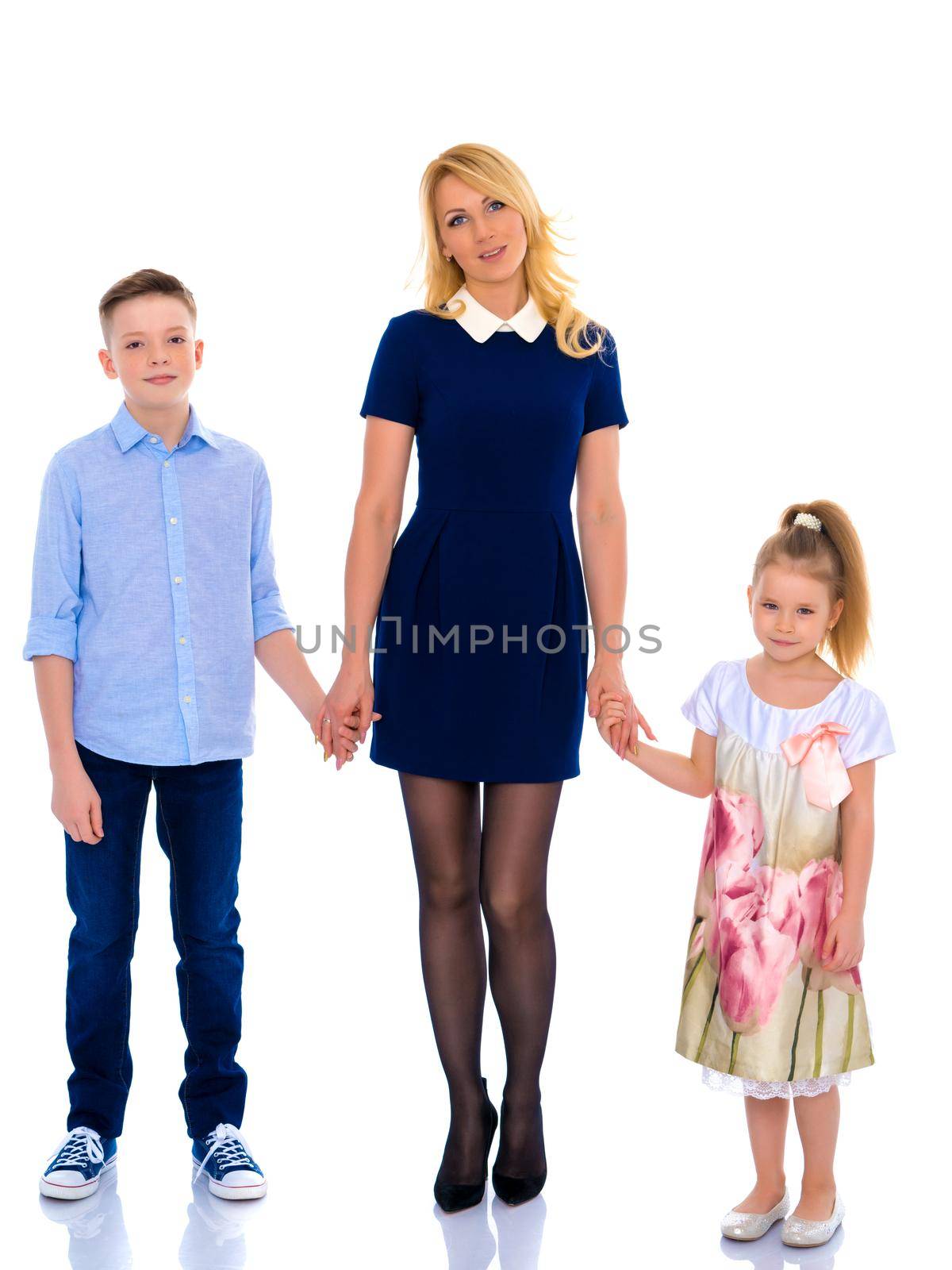 Mother with children holding hands. by kolesnikov_studio