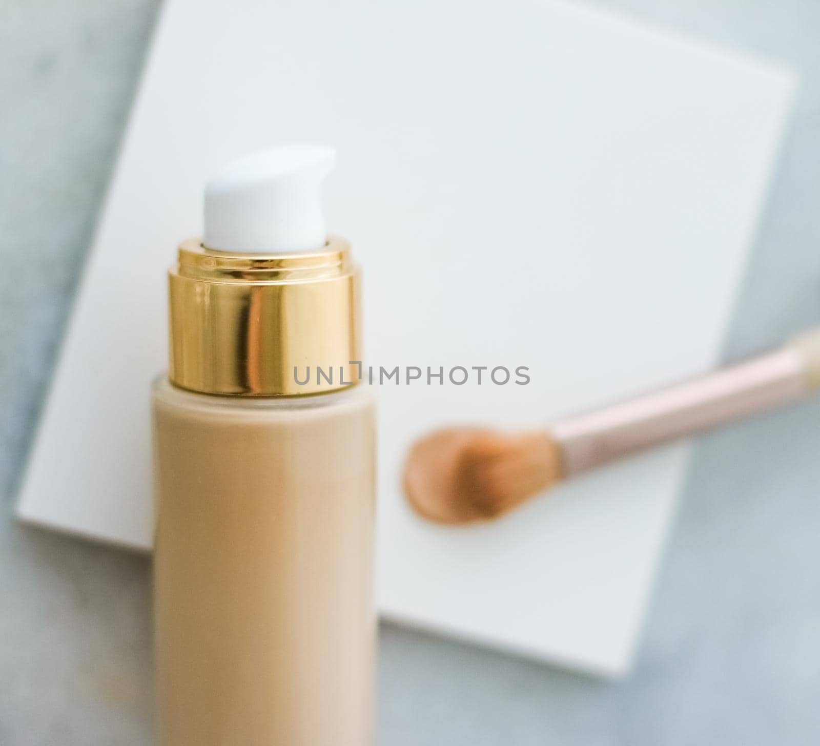 Makeup foundation bottle and contouring brush on marble, make-up concealer bb cream as cosmetics product for luxury beauty brand holiday design by Anneleven