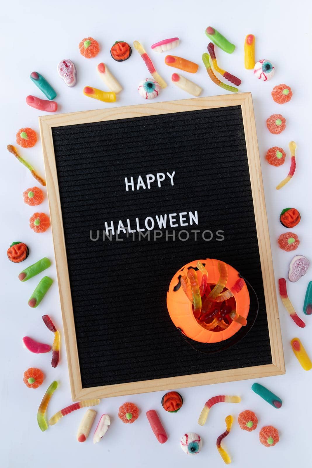 Halloween concept. Halloween party sweets with black letter board with words Happy Halloween flat lay on white background