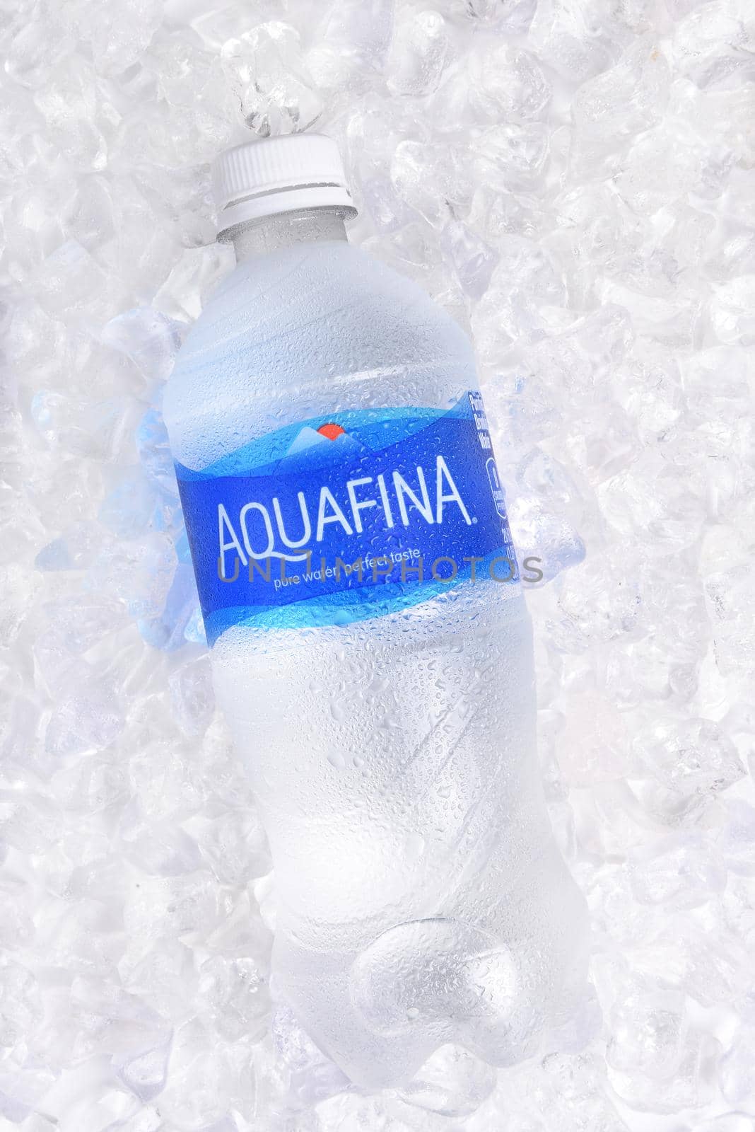 IRVINE, CALIFORNIA - JANUARY 22, 2017: Aquafina Water Bottle on ice. The purified water brand is produced by PepsiCo, in both flavored and unflavored varieties.