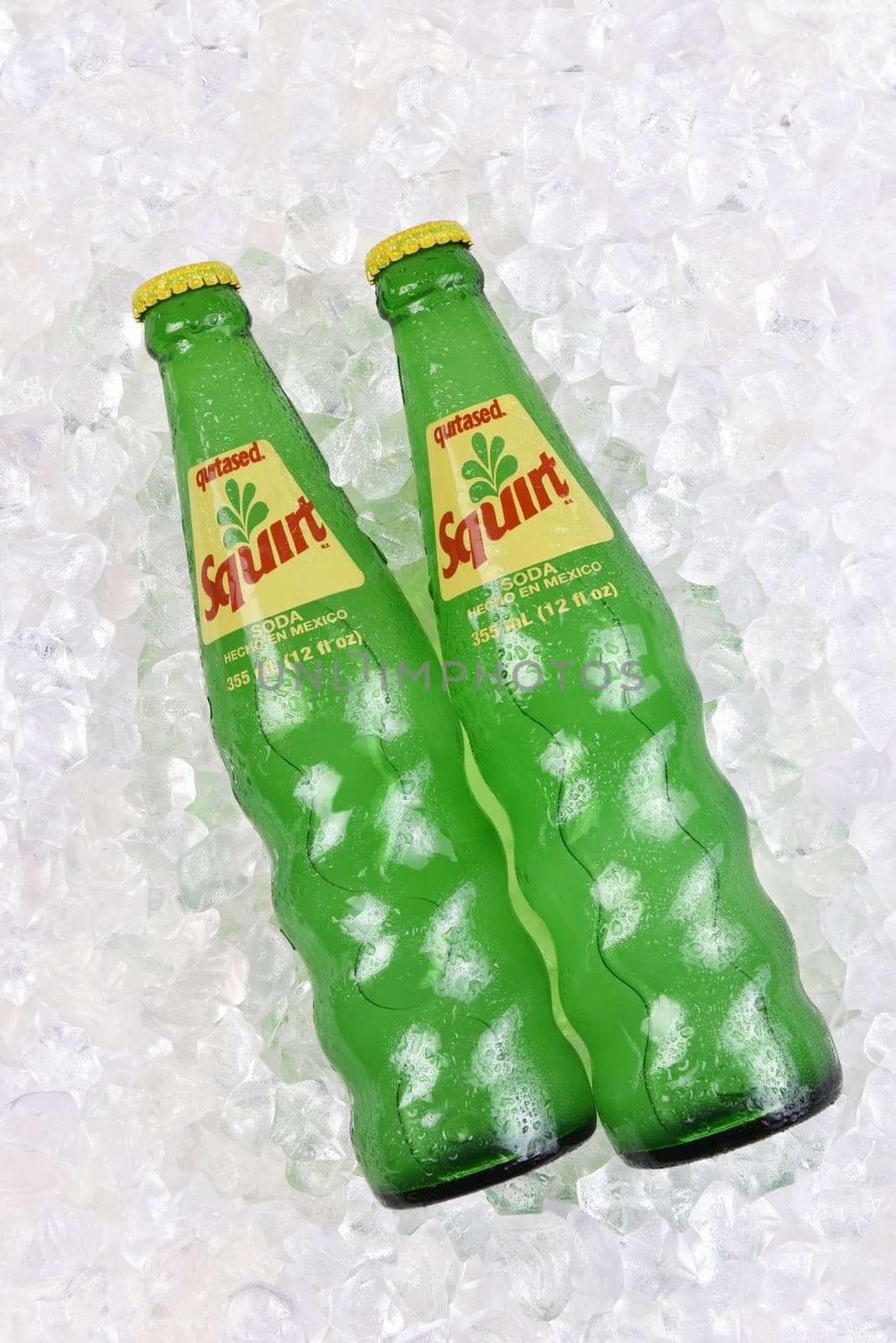 IRVINE, CALIFORNIA - 20 APRIL 2020: Two Bottles of Squirt Citrus Flavored Soft Drink in a bed of ice. Bottled in Mexico.  by sCukrov