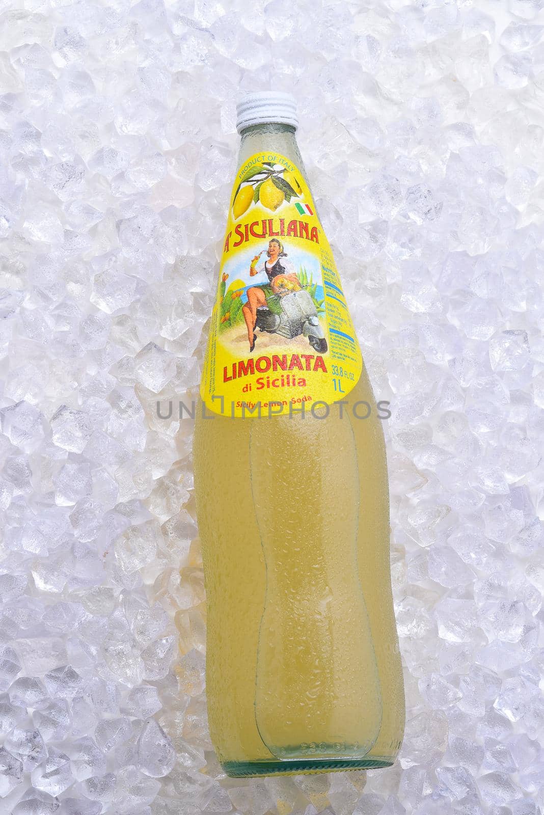 A  bottle of A Siciliana Limonata, a carbonated lemon soda from Italy, on ice by sCukrov
