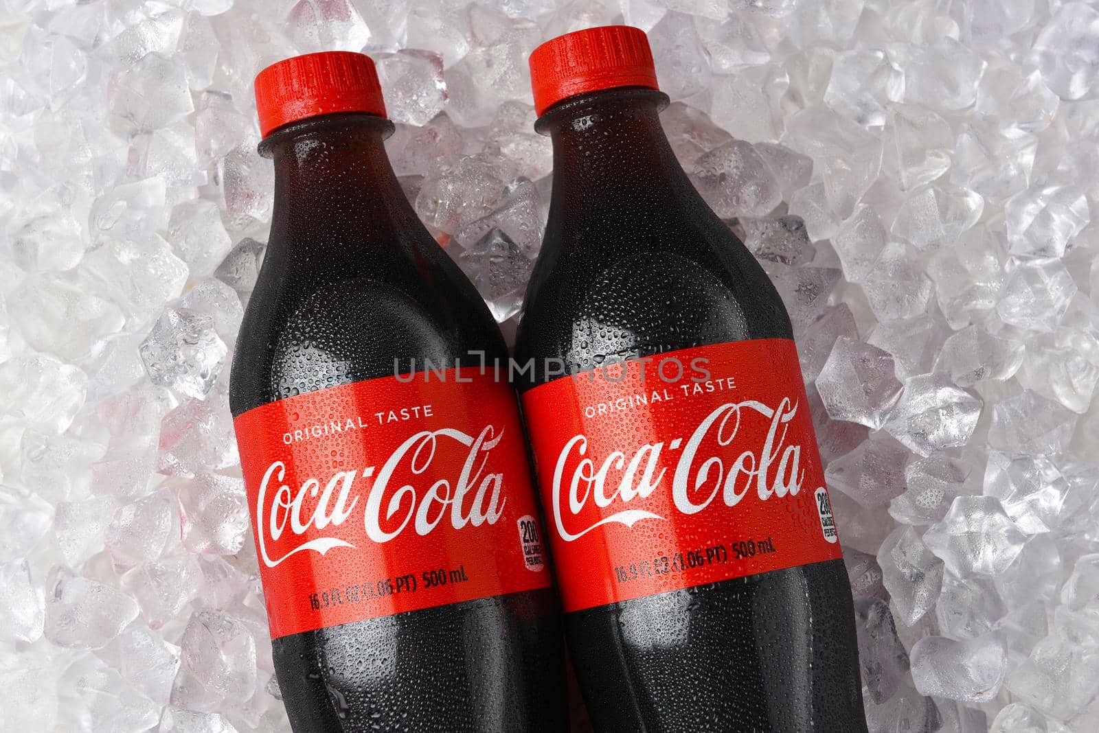 IRVINE, CALIFORNIA - 26 JUNE 2021: Closeup of two plastic bottles of Coca-Cola in a bed of ice. by sCukrov