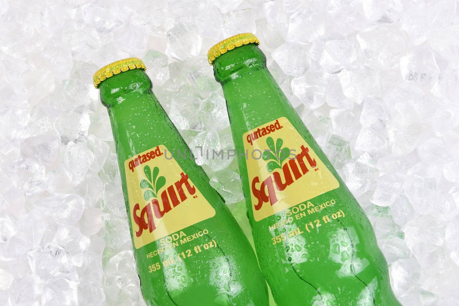 IRVINE, CALIFORNIA - 20 APRIL 2020: Closeup of two Bottles of Squirt Citrus Flavored Soft Drink in a bed of ice. Made in Mexico.
