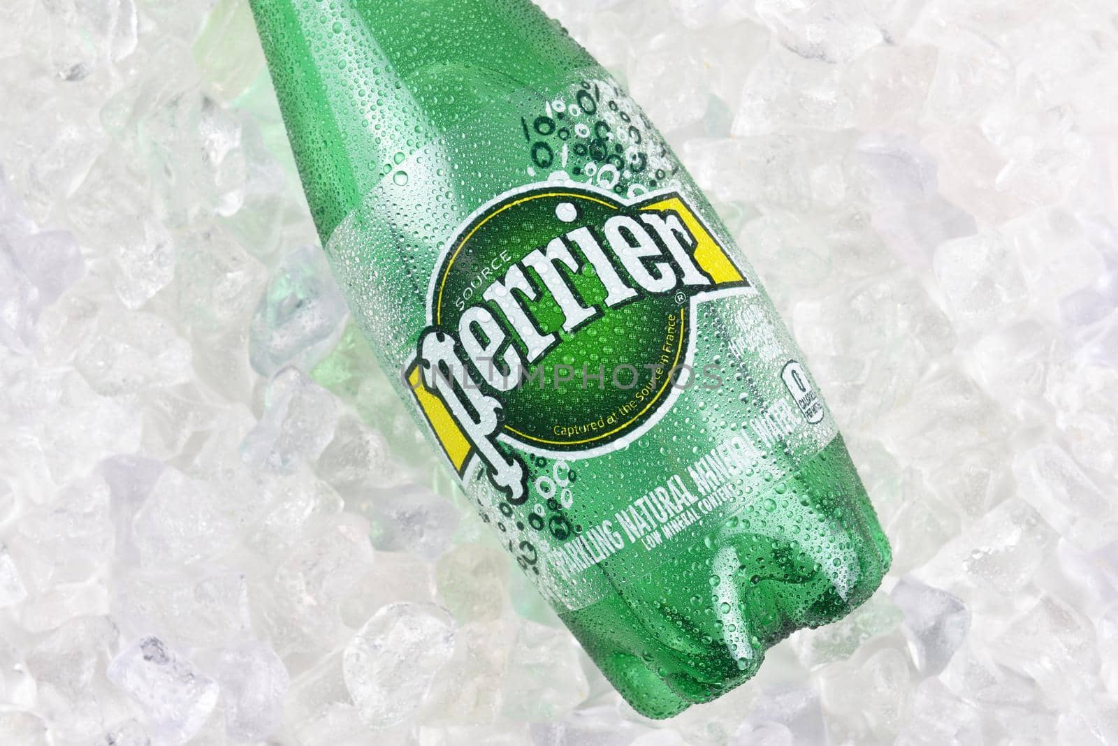 IRVINE, CALIFORNIA - DECEMBER 17, 2017: Perrier Sparkling Mineral Water on ice closeup. The spring, in Vergeze, France, where the water is sourced is naturally carbonated.