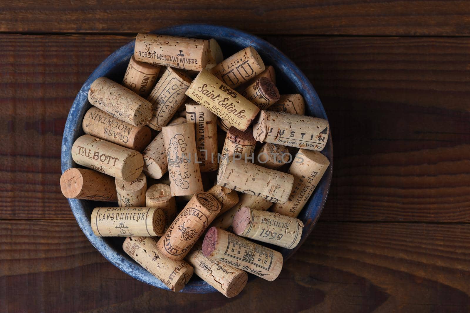 IRIVNE, CALIFORNIA - 26 JAN 2020: A group of branded wine corks in a bowl from domestic and foreign wineries.