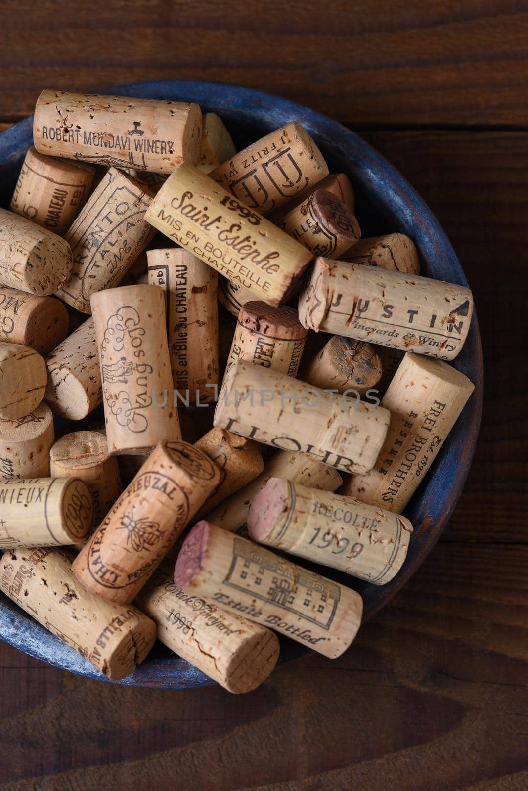IRIVNE, CALIFORNIA - 26 JAN 2020: High angle closeup of a group of branded wine corks in a bowl from domestic and foreign wineries.