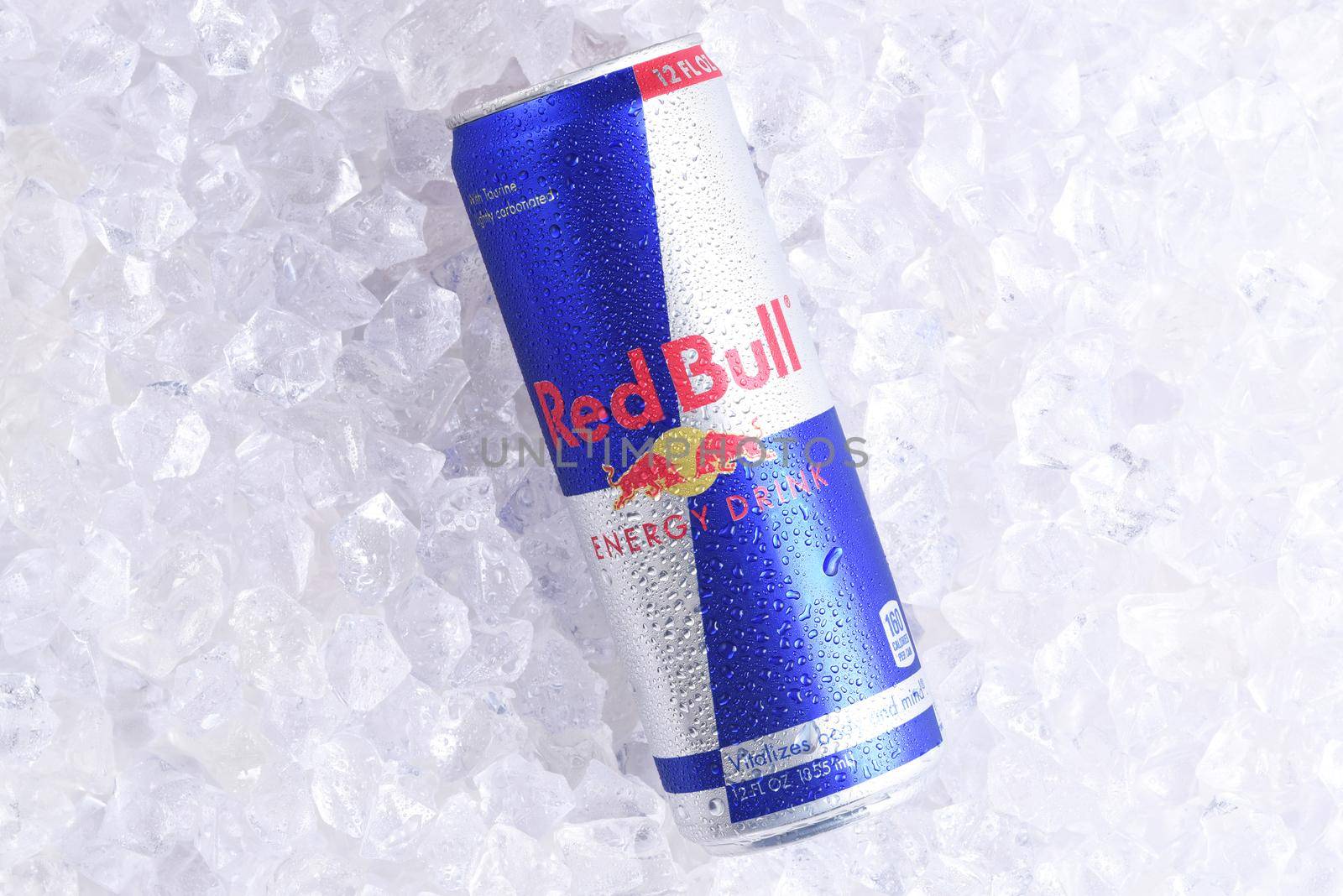 IRVINE, CALIFORNIA - MAY 23, 2018: A single can of Red Bull Energy Drink on ice. Red Bull is the most popular energy drink in the world.