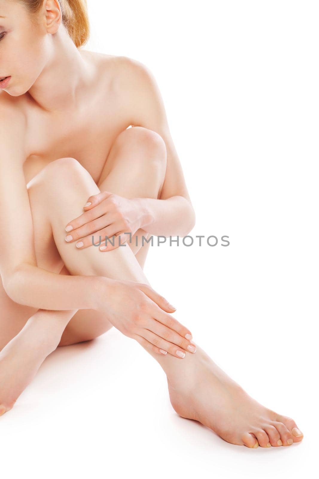 picture of healthy naked woman sitting in studio over white