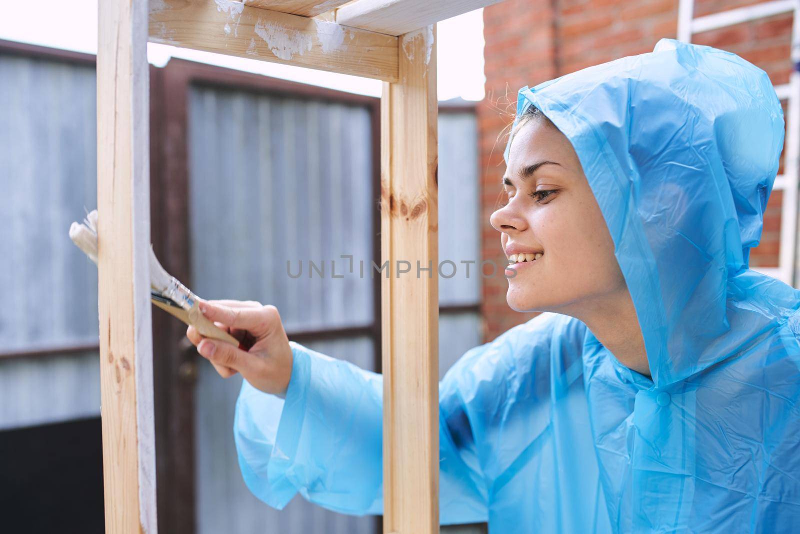 woman paints wooden objects painter decoration home renovation. High quality photo