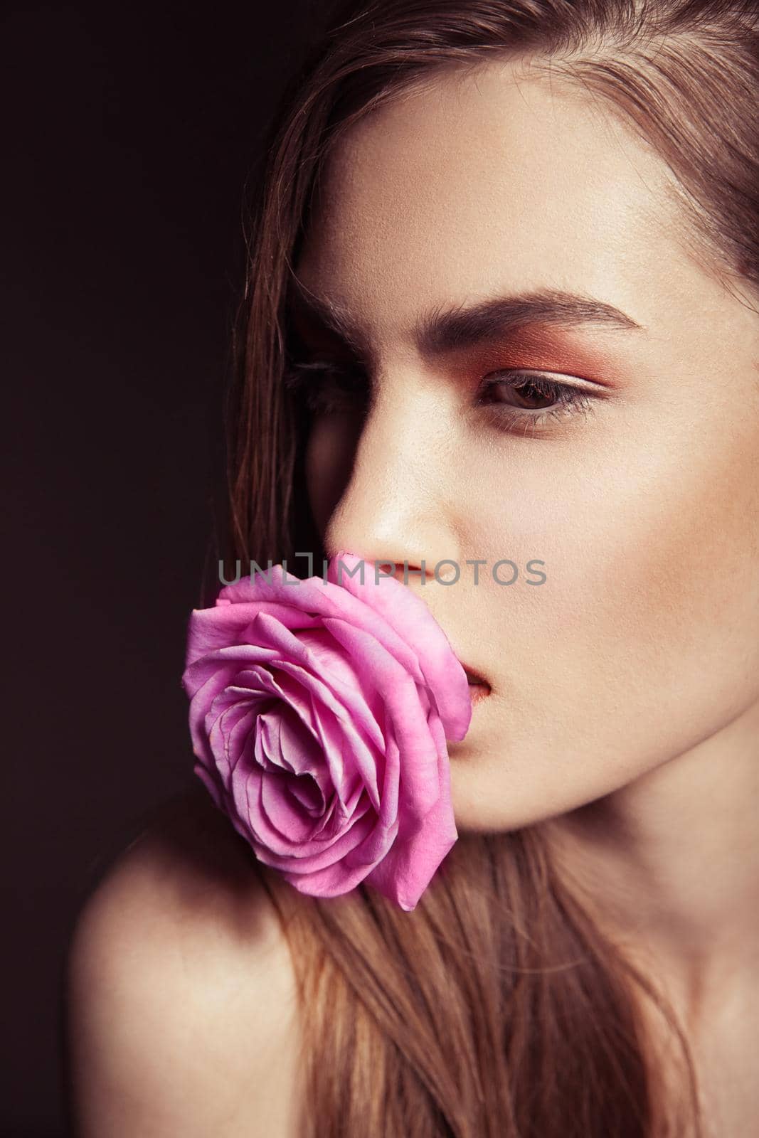 Portrait of beautiful brunette woman with rose by Julenochek