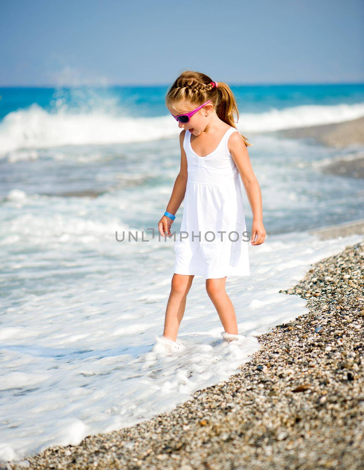 Adorable little girl on tropical beach vacation