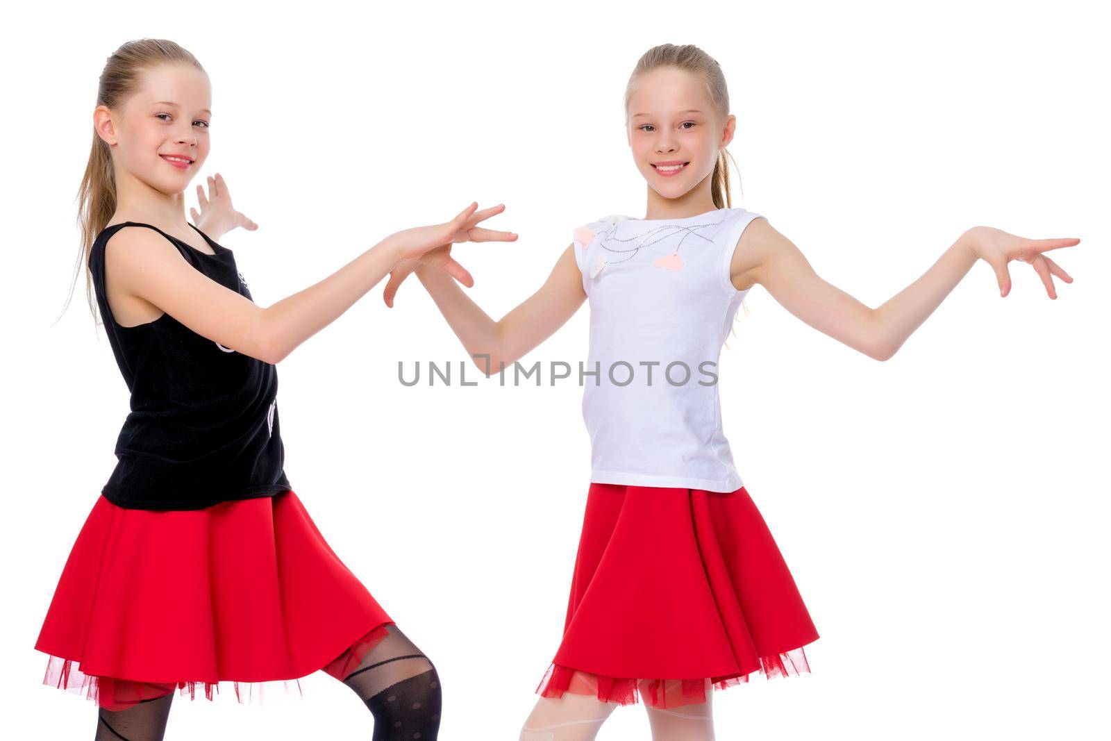 Two cheerful little girls are dancing. by kolesnikov_studio