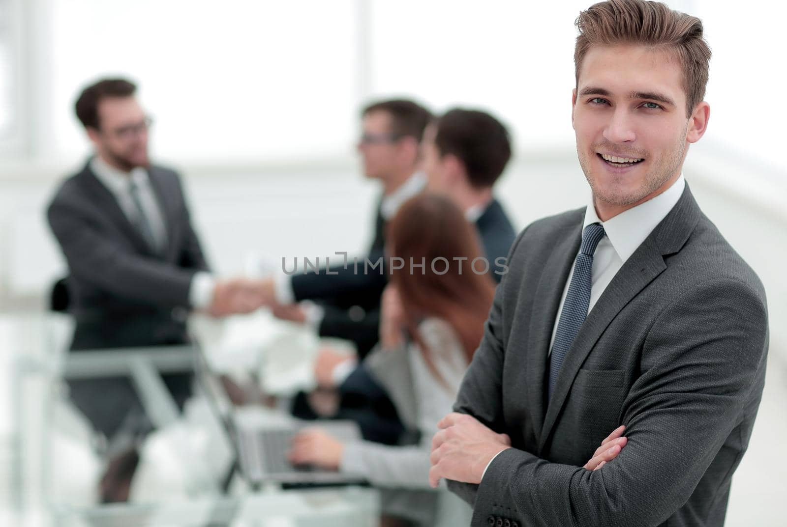 young businessman on blurred office background by asdf