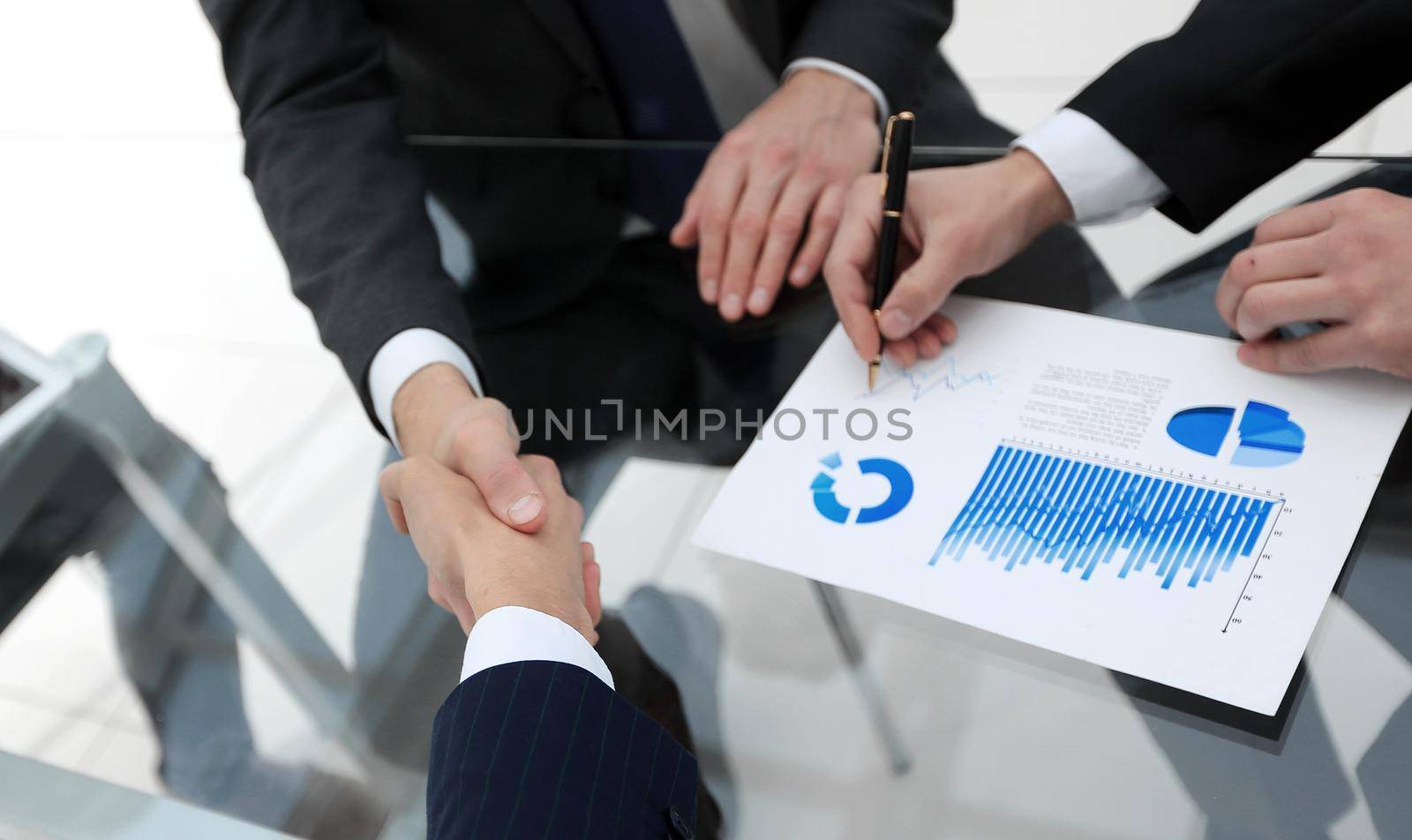 handshake of financial partners at the Desk.