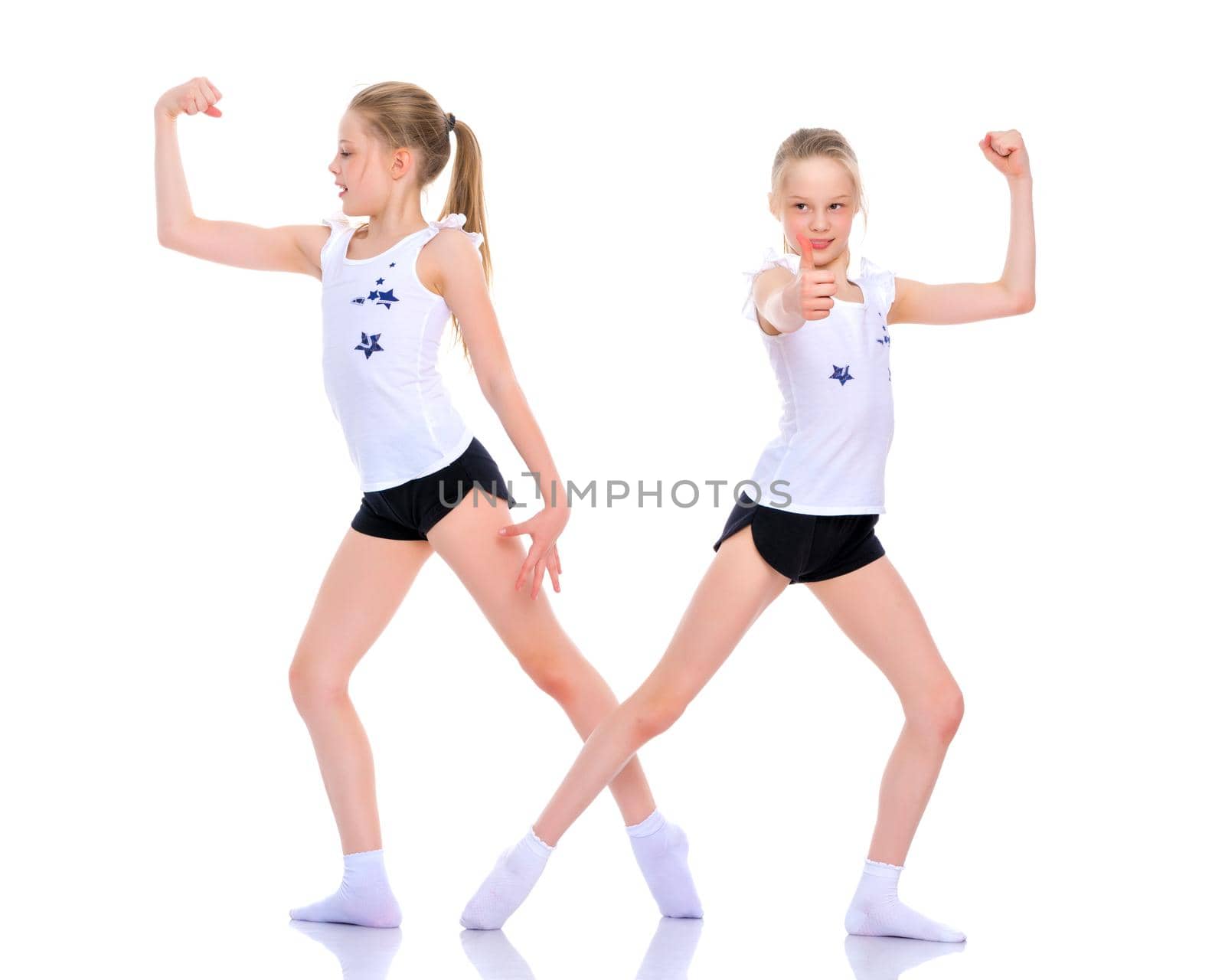 Jolly girls gymnasts are engaged in fitness, They show their muscles. Concept of children's sport, Happy people. Isolated on white background.