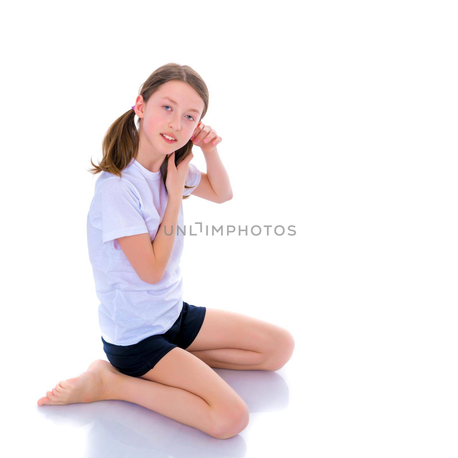 A sweet girl straightens her hair. The concept of fashion and style. Isolated over white background