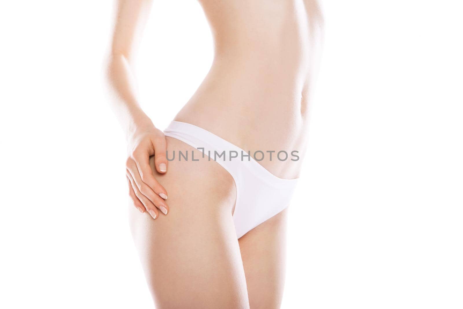 Slim tanned woman's body isolated over white background