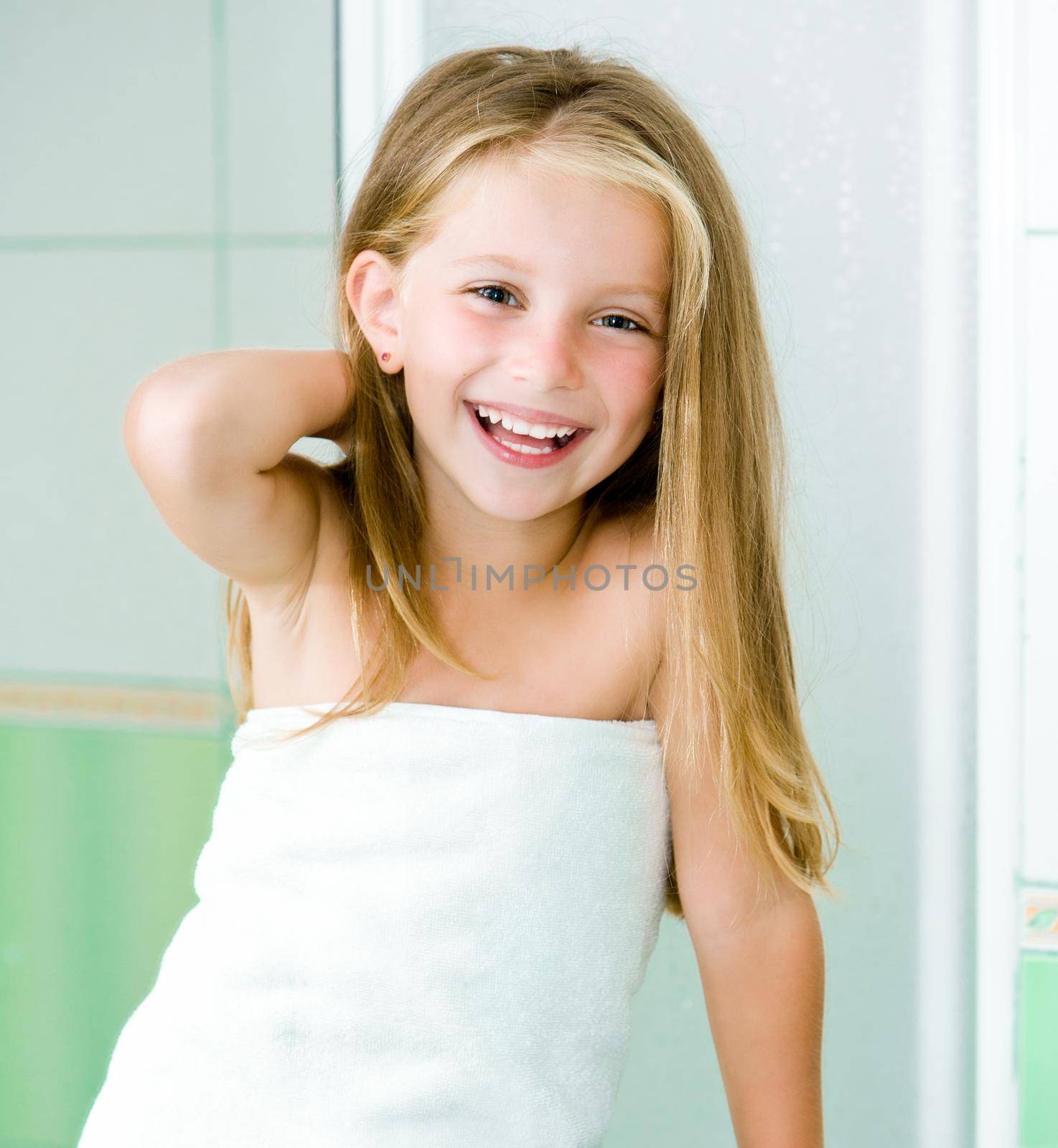 Cute little girl washing in bath