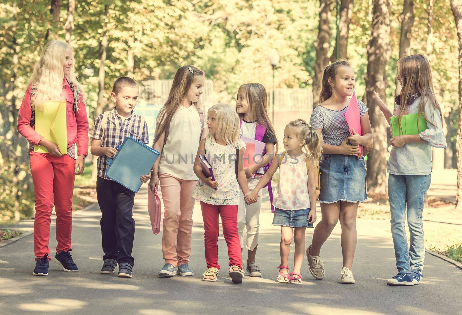 group of children with school backpacks in the park