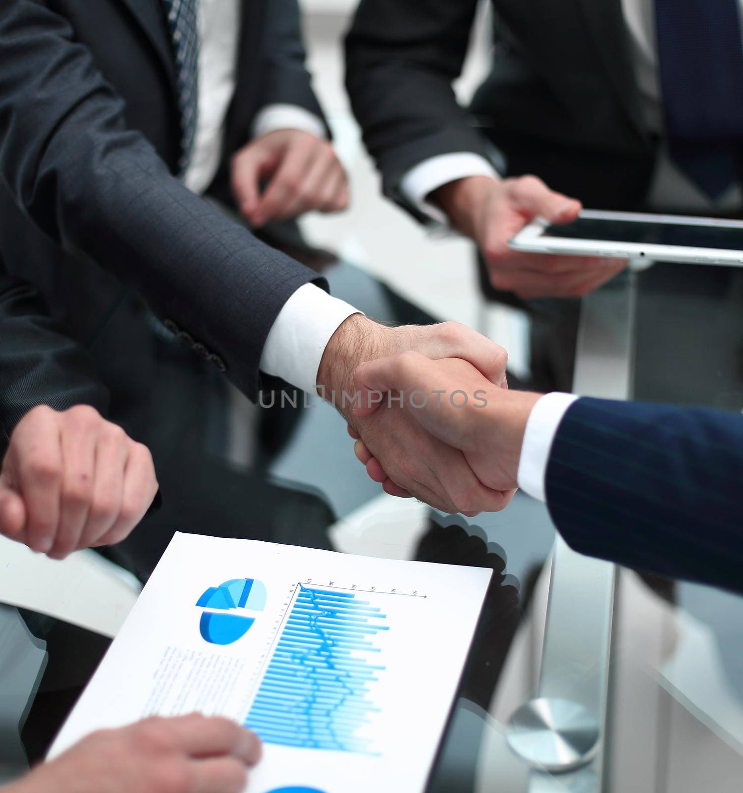 close up. investor and businessman shaking hands by asdf