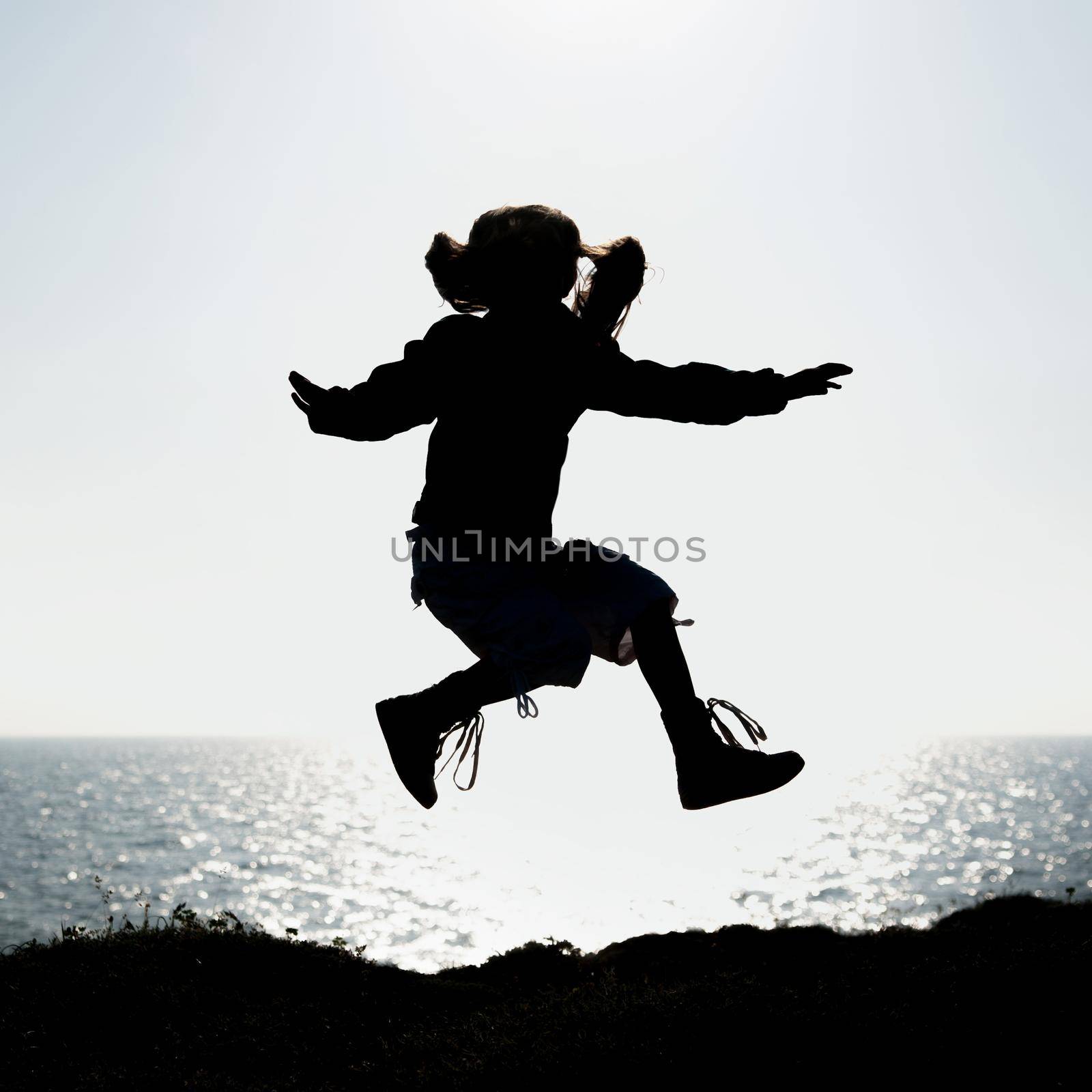 silhouette of a little girl jumping by tan4ikk1