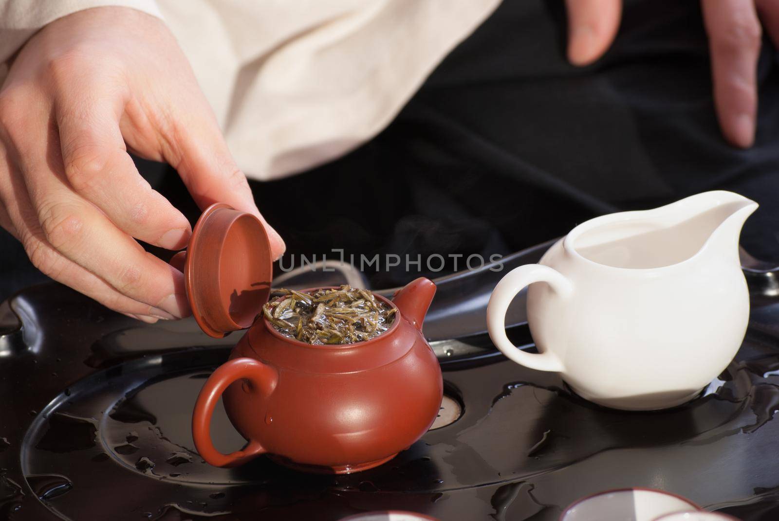 Chinese tea ceremony is perfomed by tea master in kimono