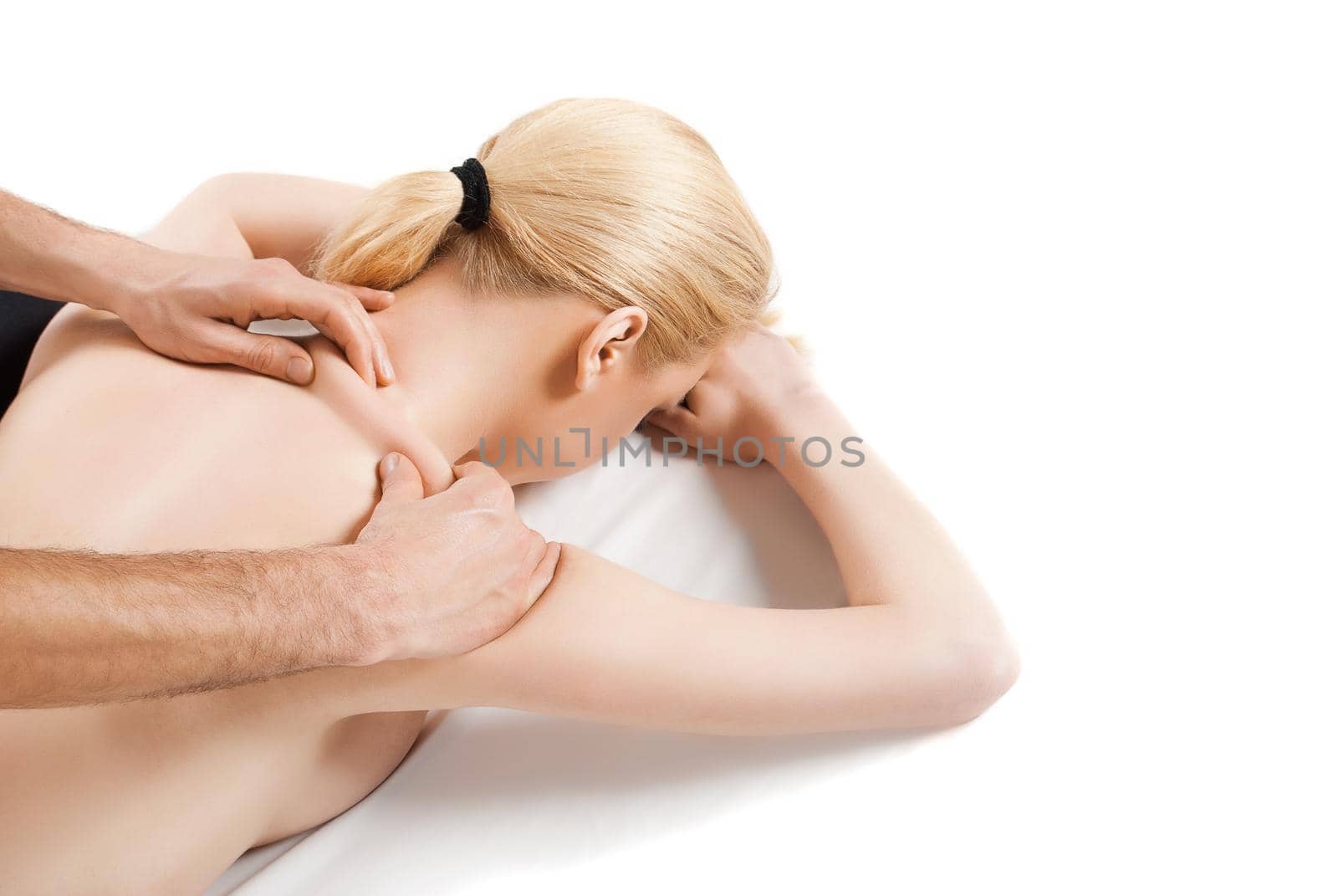 girl getting a massage - hands massaging her back - A pretty woman getting a shoulder and back massage