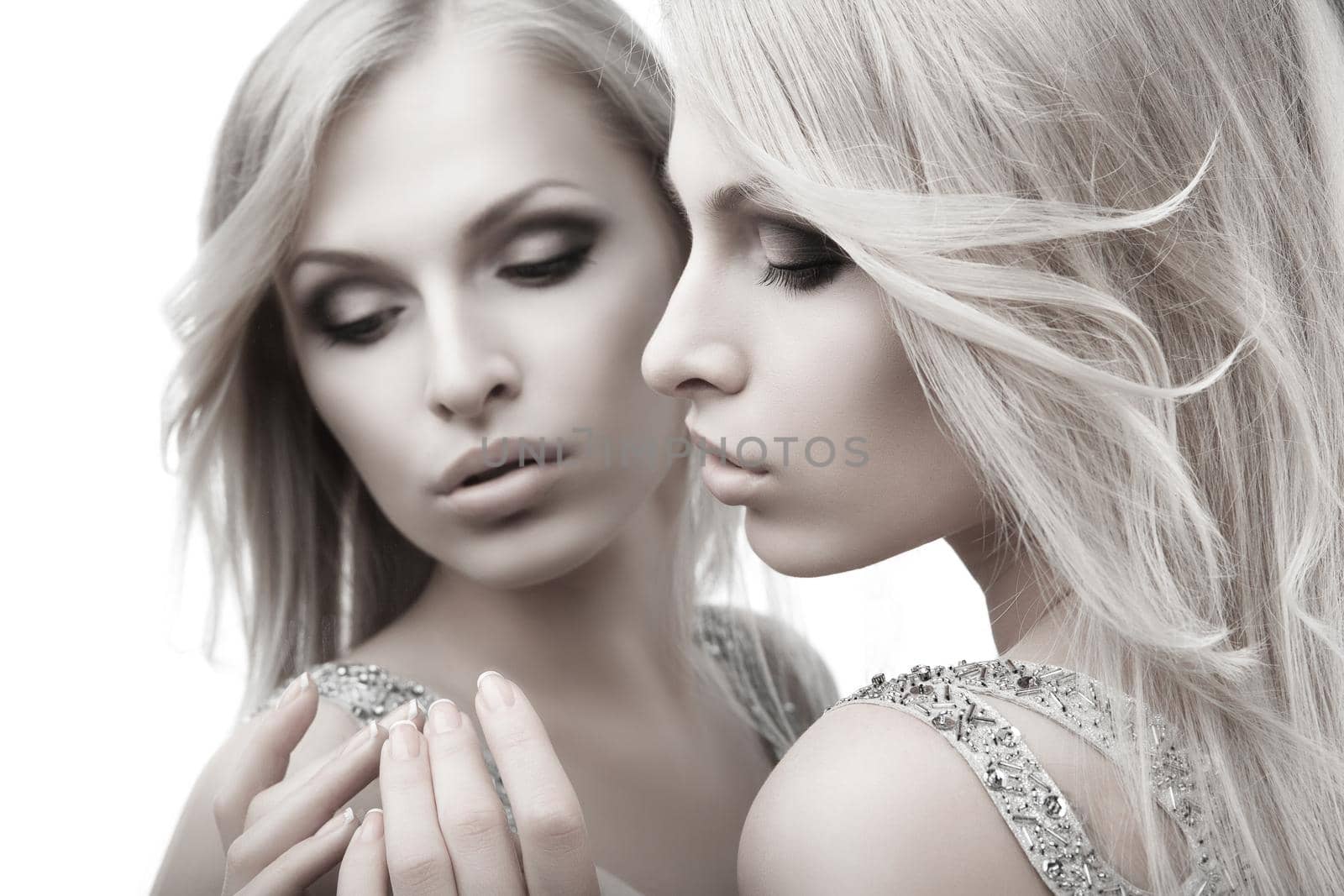 Beautiful sexy young woman near mirror over white by Julenochek