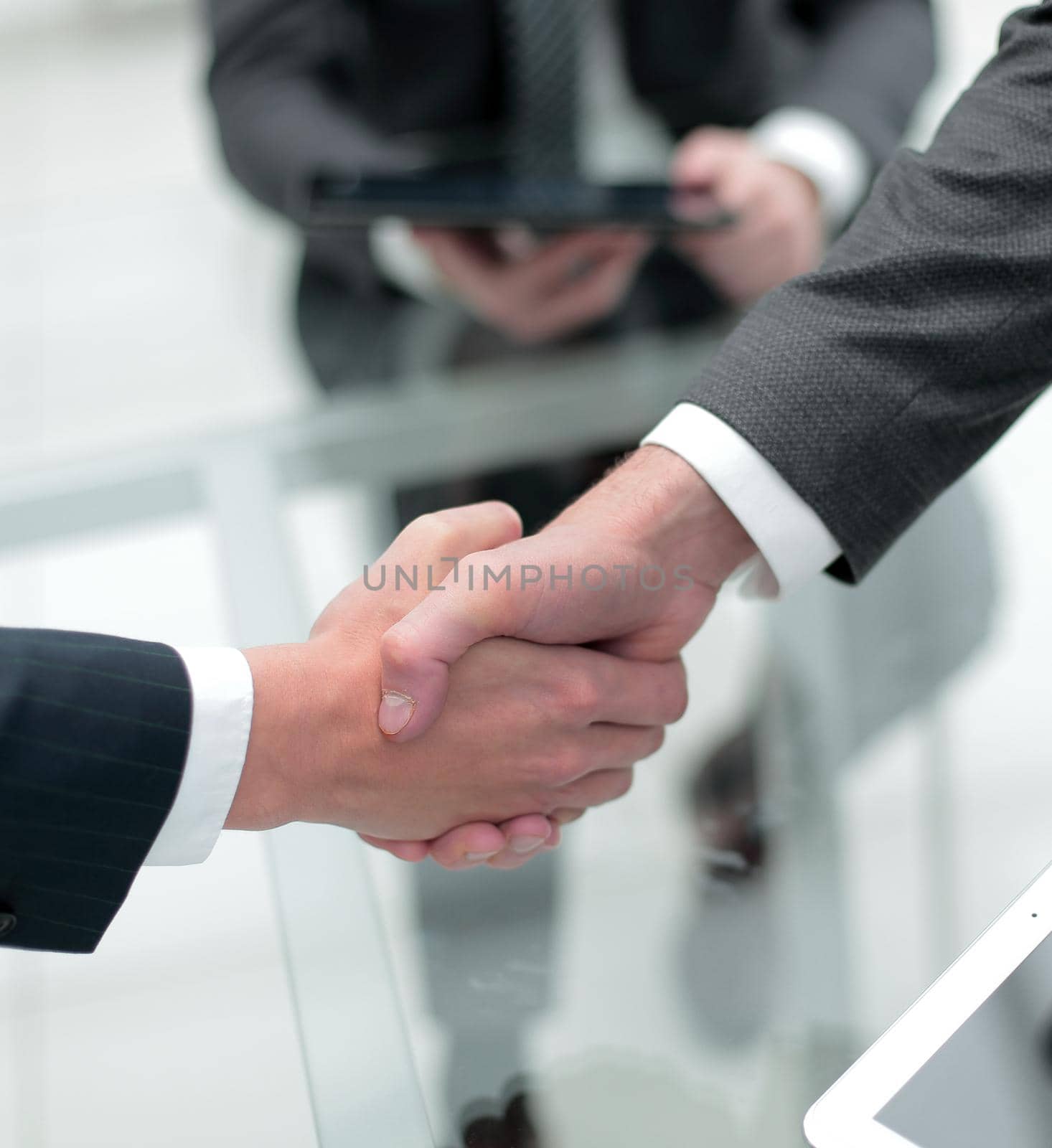 close up.financial partners handshake by asdf