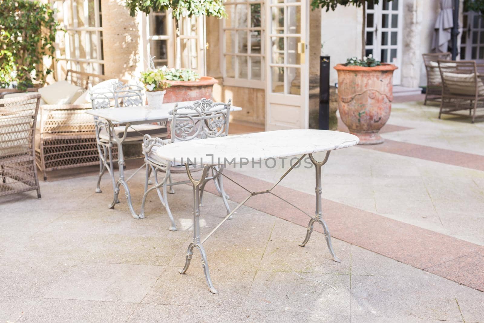 Cafe, coffee shop, tavern and restaurant concept - Outdoor street cafe tables ready for service. by Satura86