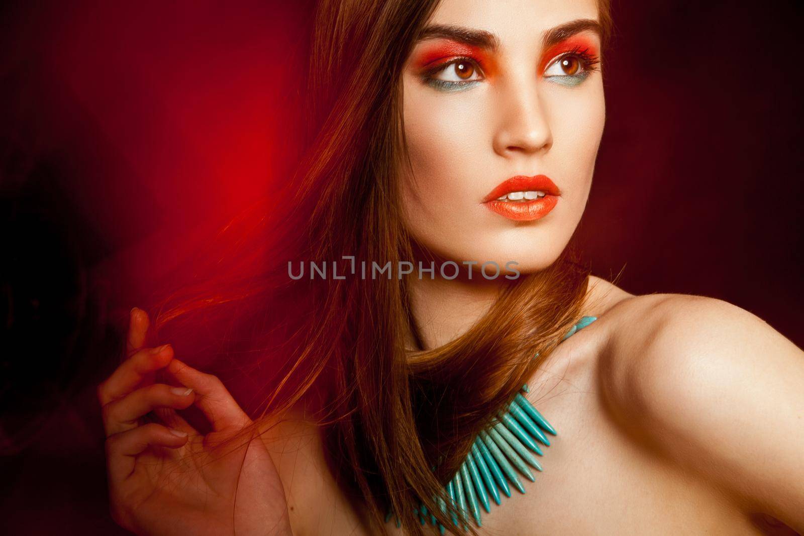 Beautyful woman with creative make-up over dark background