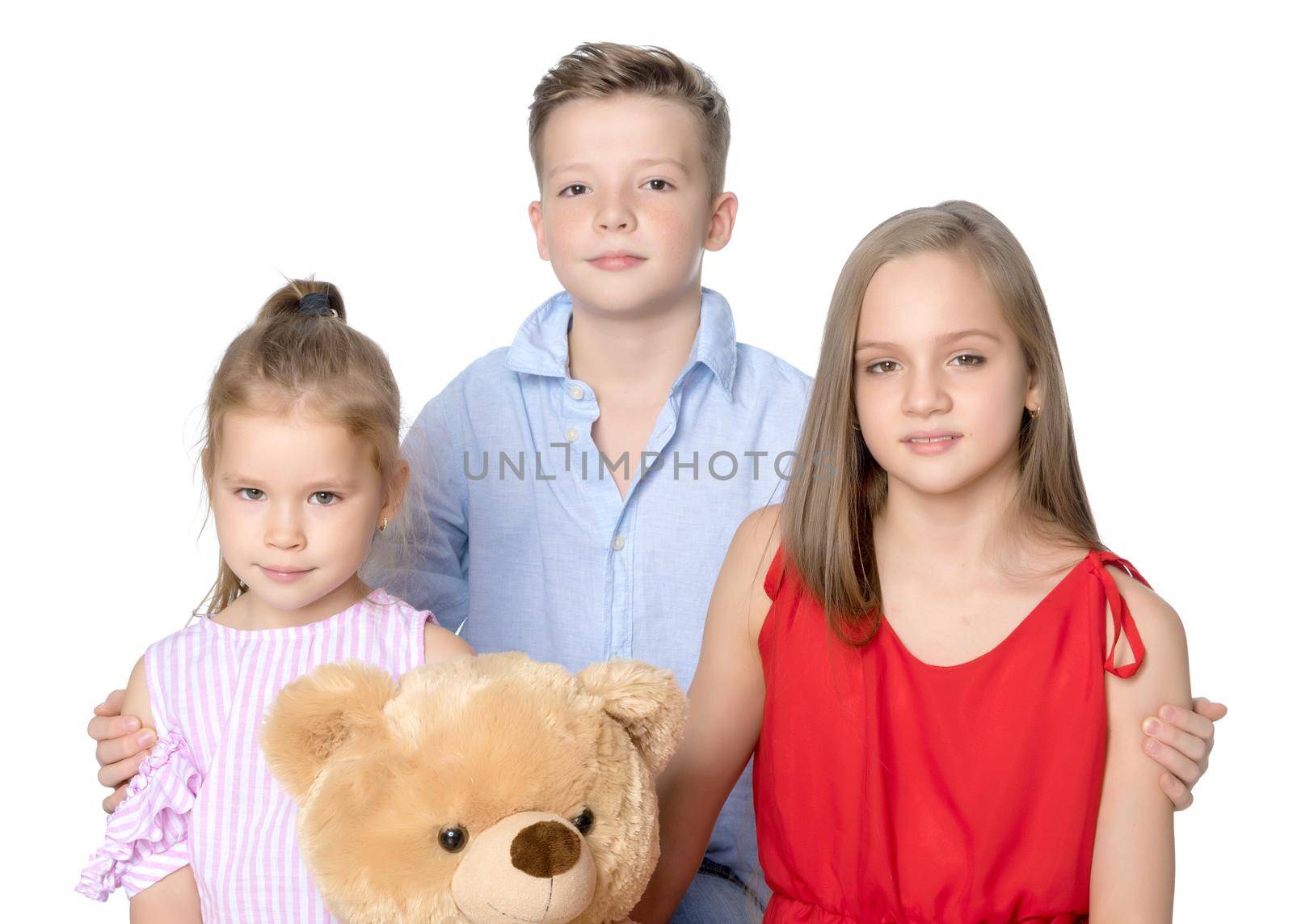 Brother and two sisters with a teddy bear by kolesnikov_studio