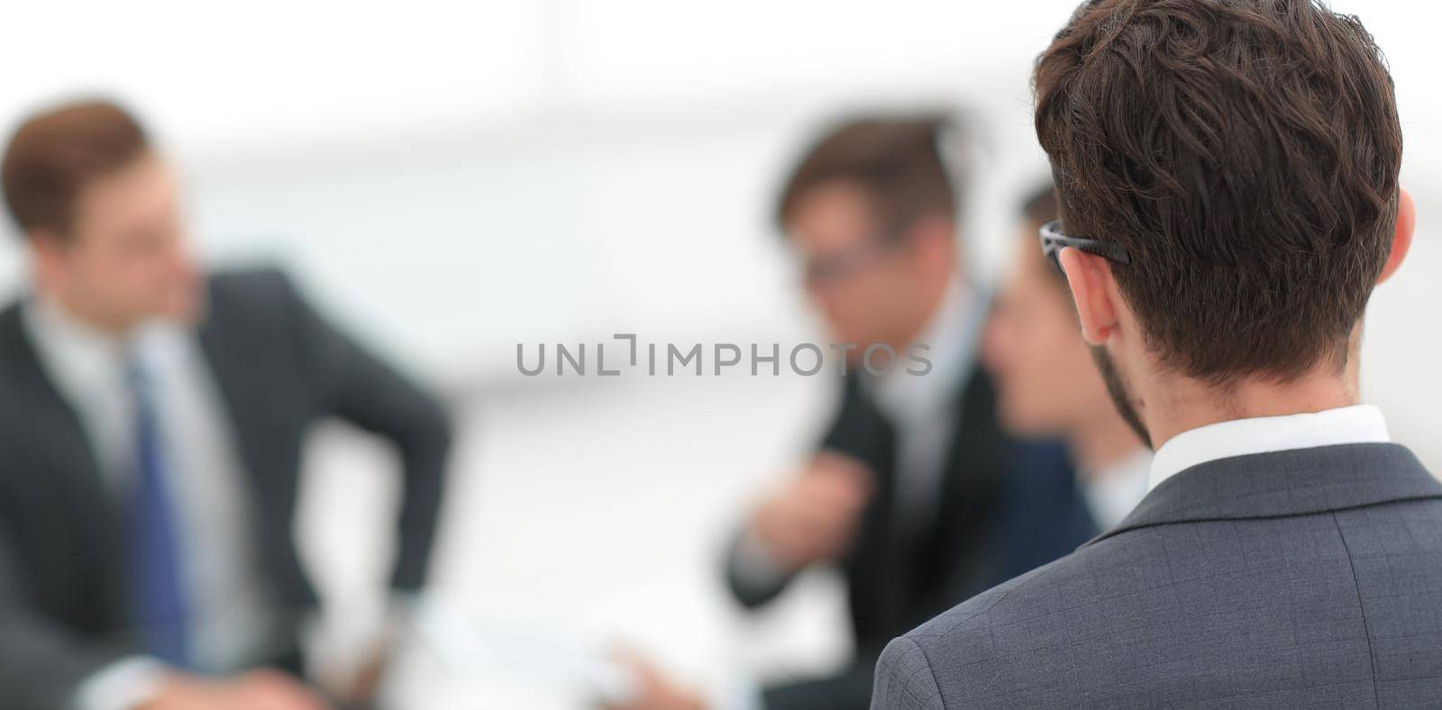 businessman on blurred office background by asdf