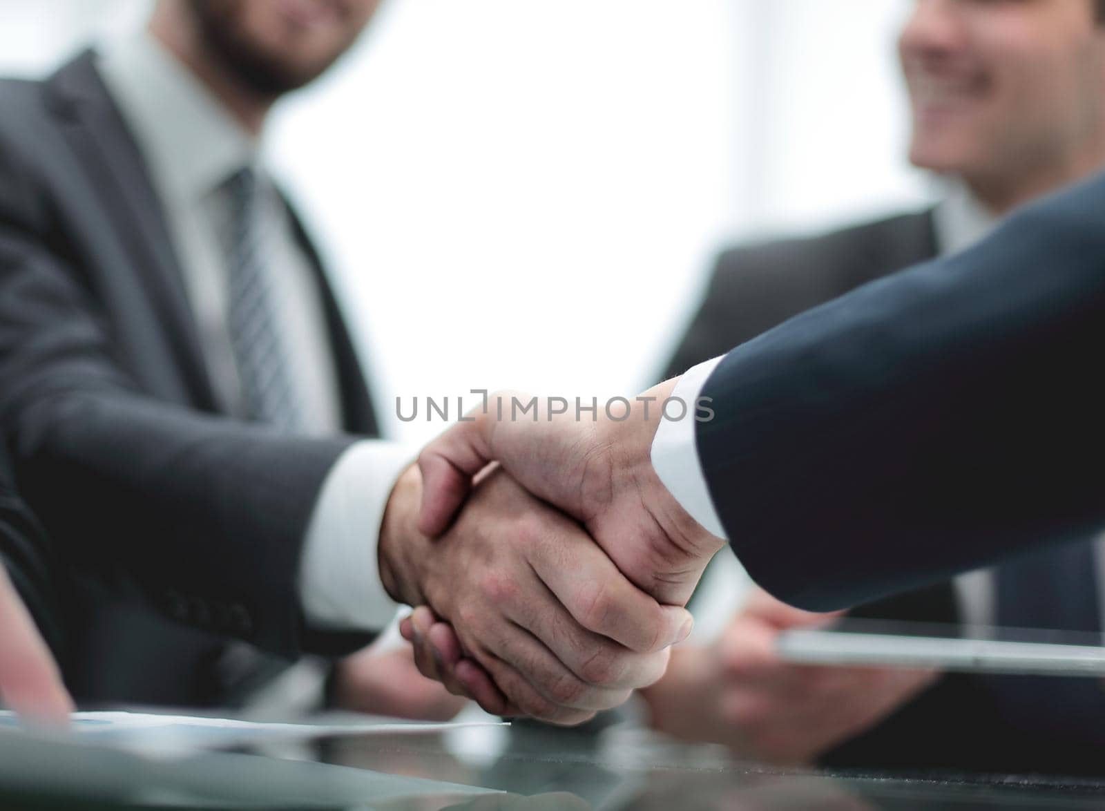Close-up image of a firm handshake by asdf