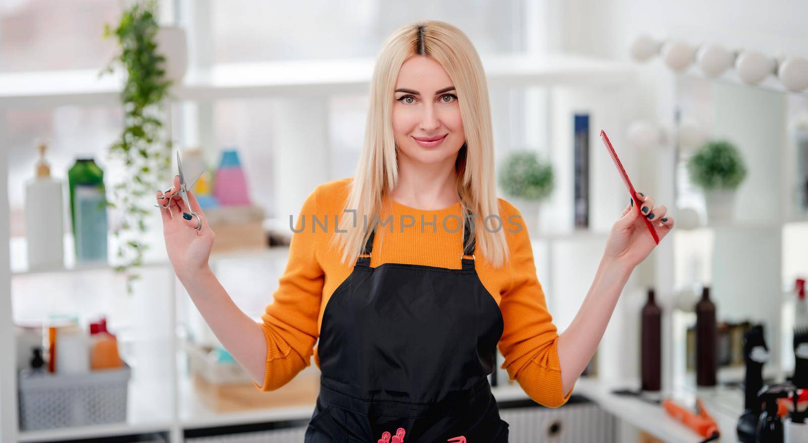 Professional hairdresser blond woman with scissors and hair brush