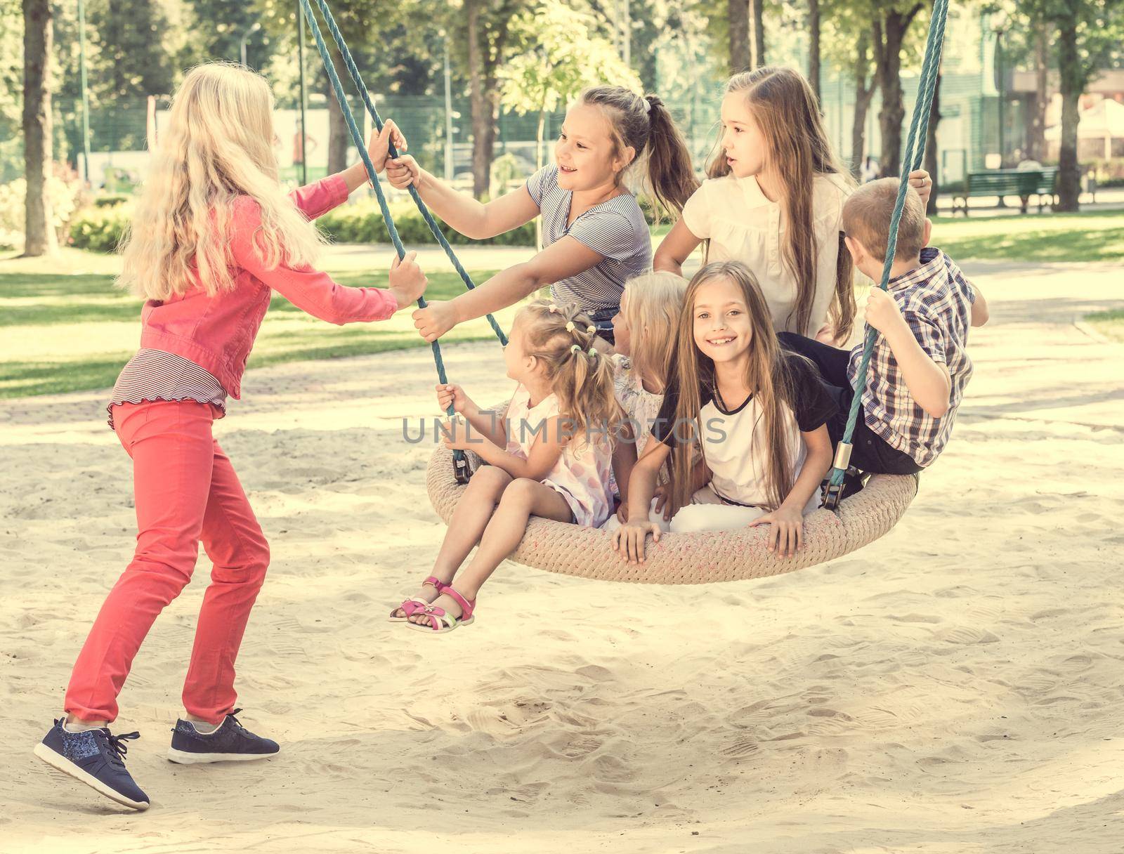 Blond girl swinging little kids by tan4ikk1